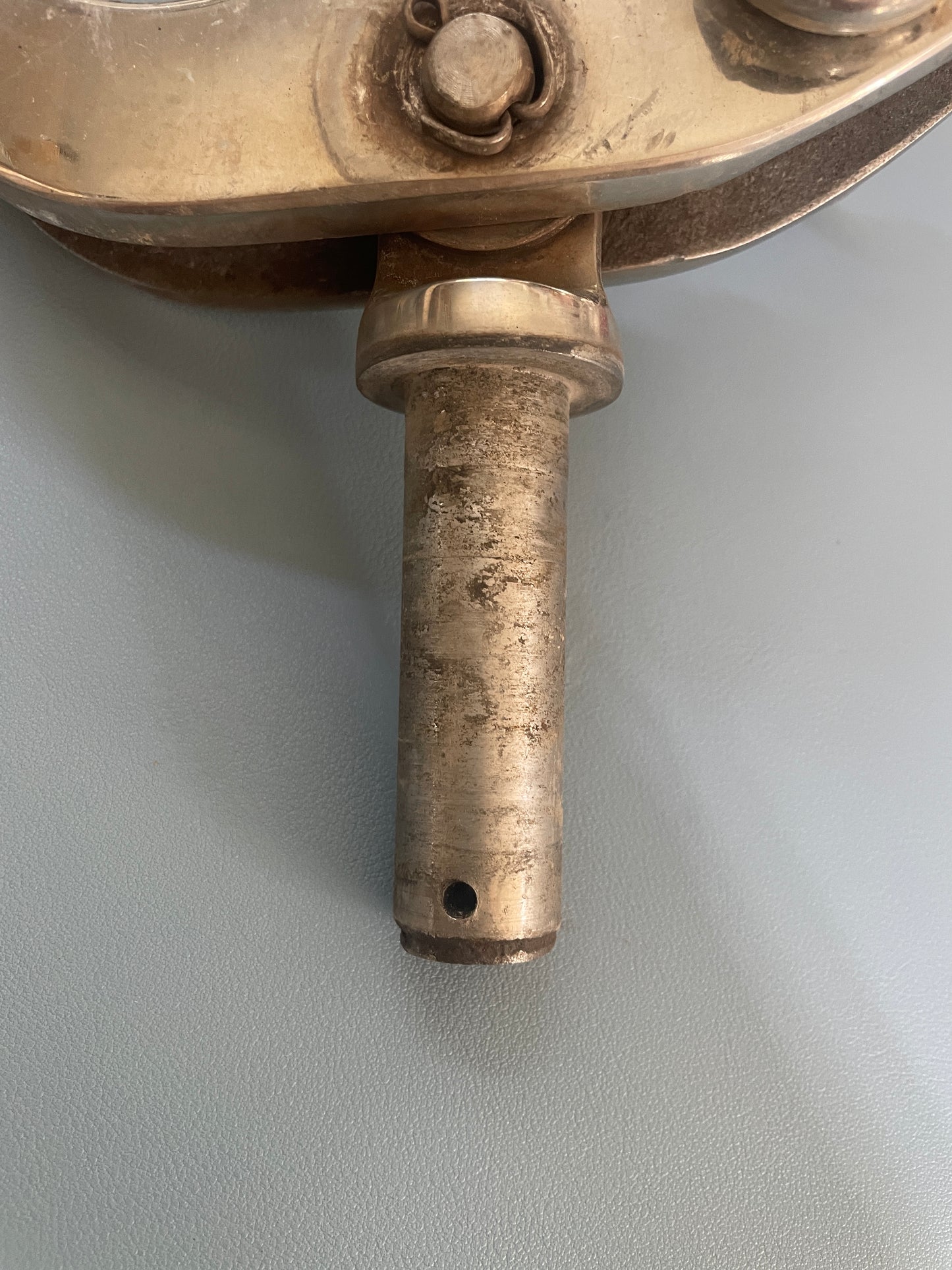 Metallic cylindrical component on a plain background