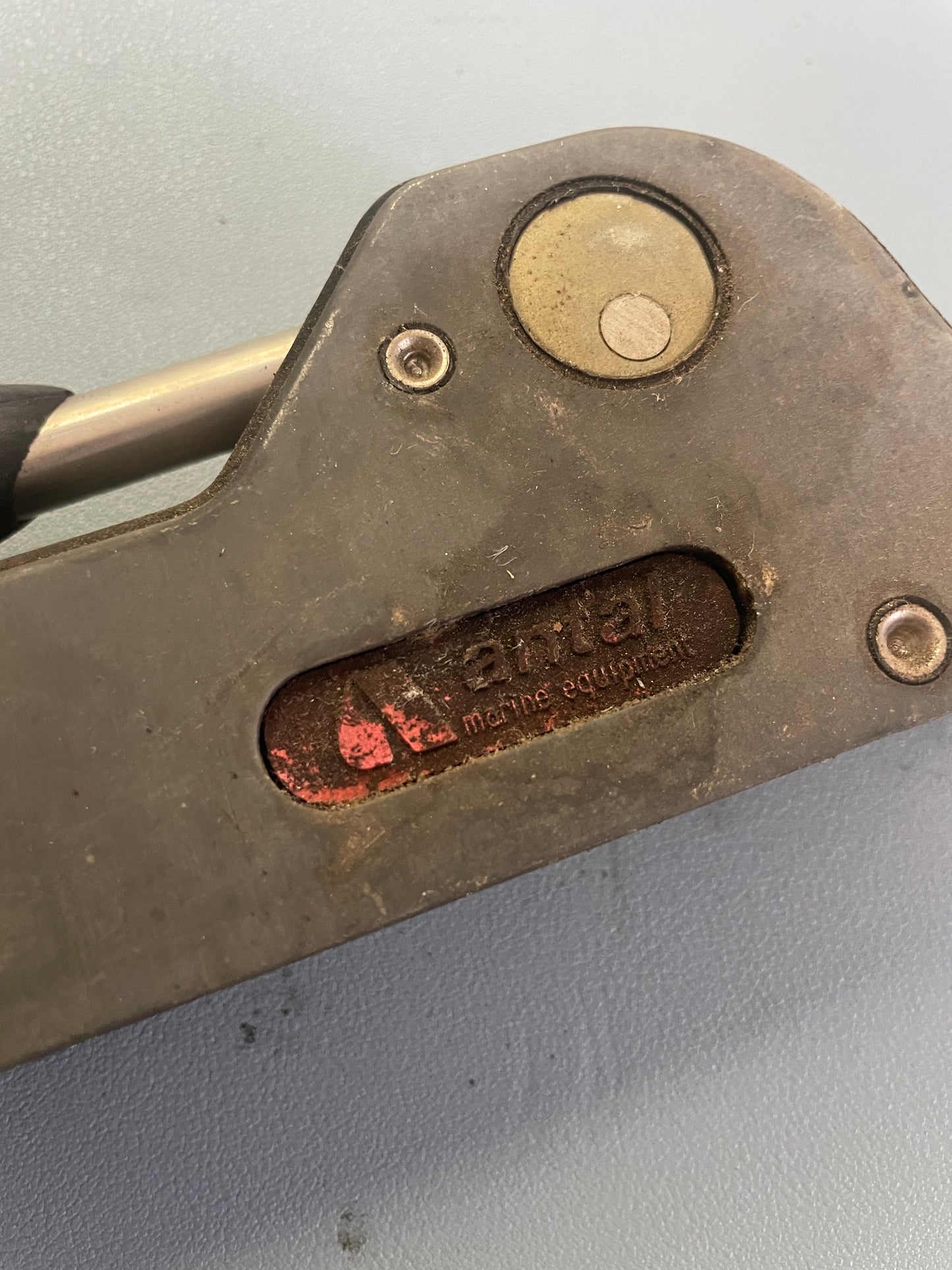 Close-up of a tool with a brand logo on a gray background
