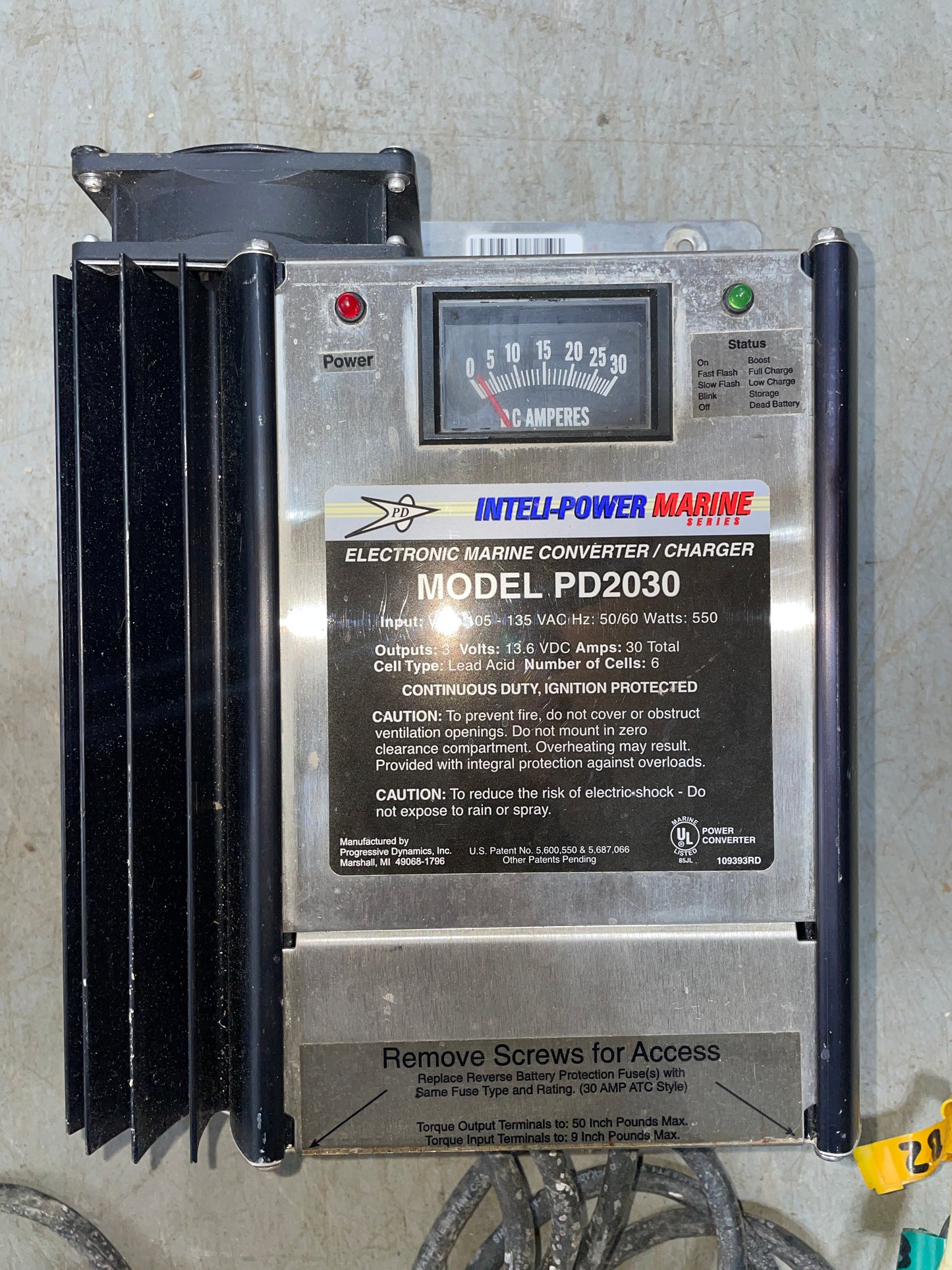 Marine converter charger with label on a concrete surface