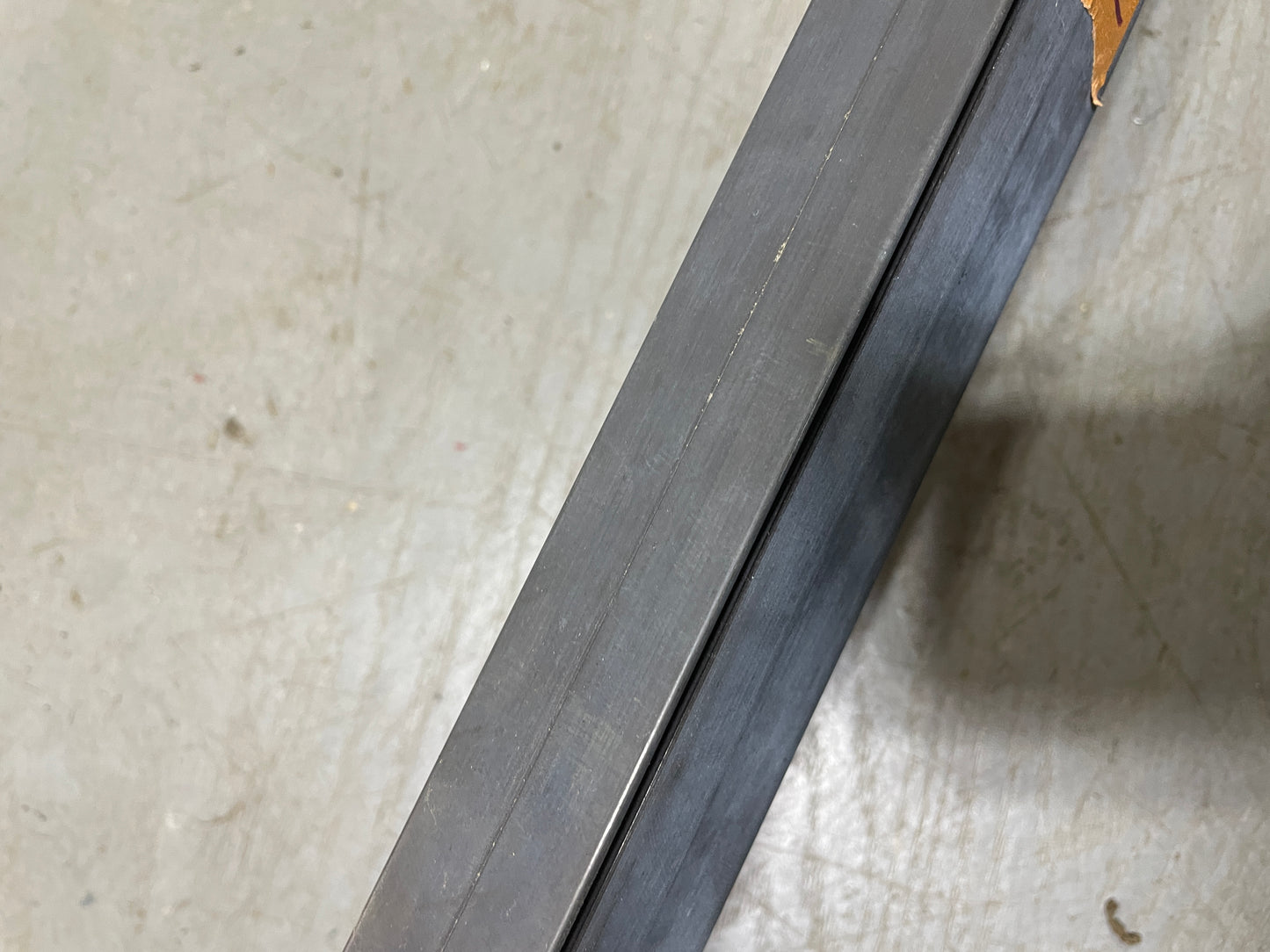 Close-up of a metal strip on a textured surface