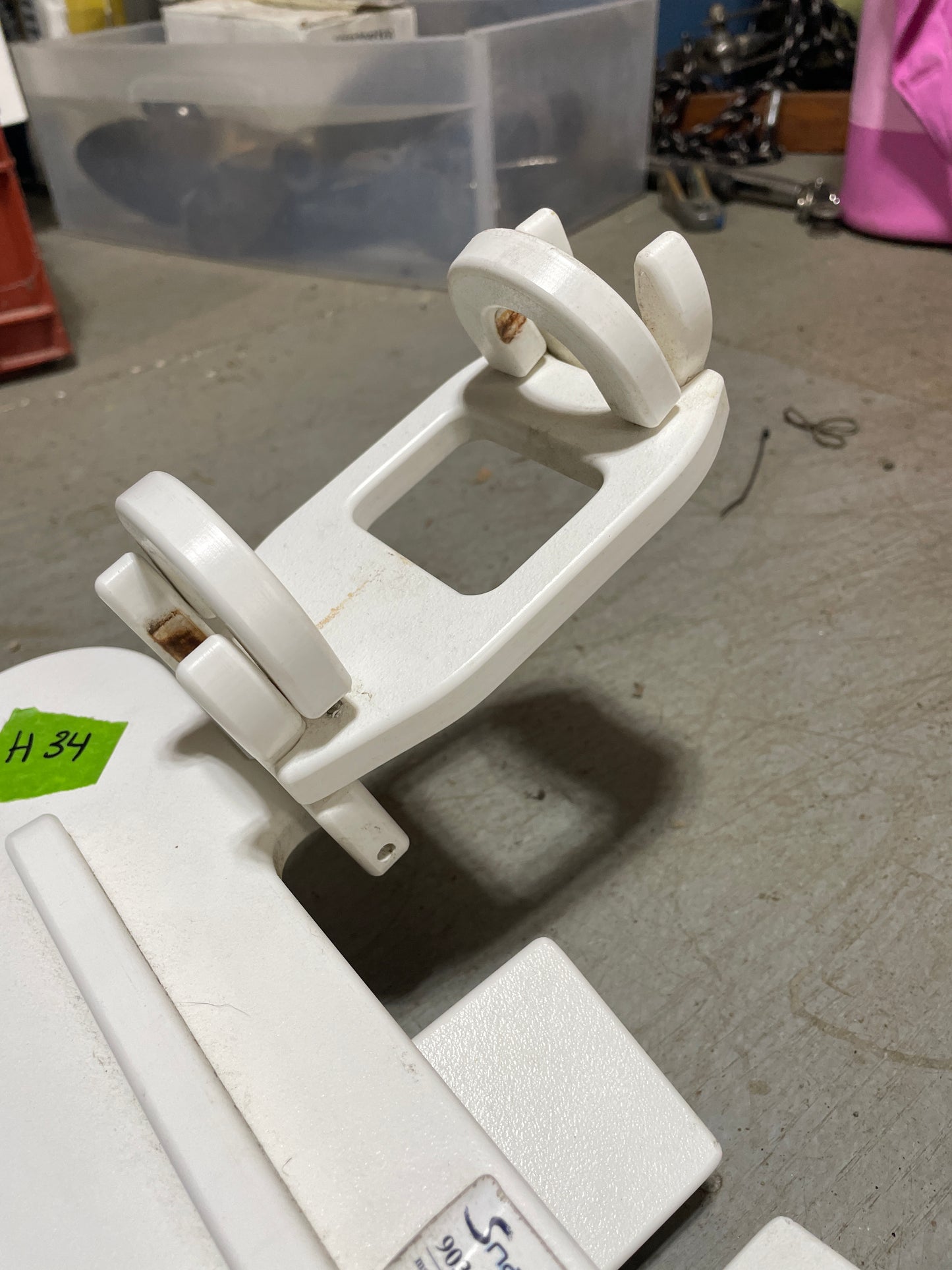 White plastic clamp on a gray surface with a blurred background