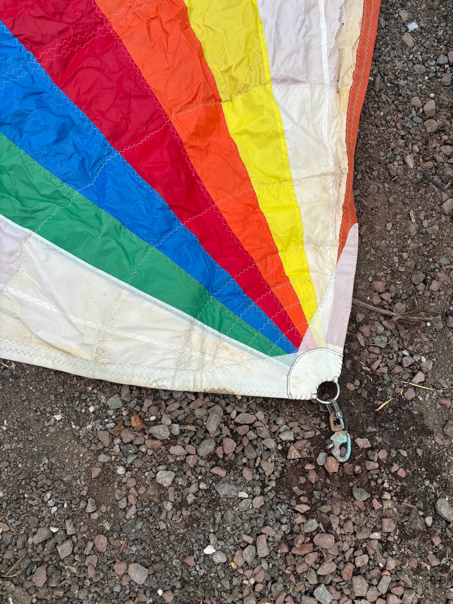 Multicolored fabric with rainbow pattern on a rough ground surface