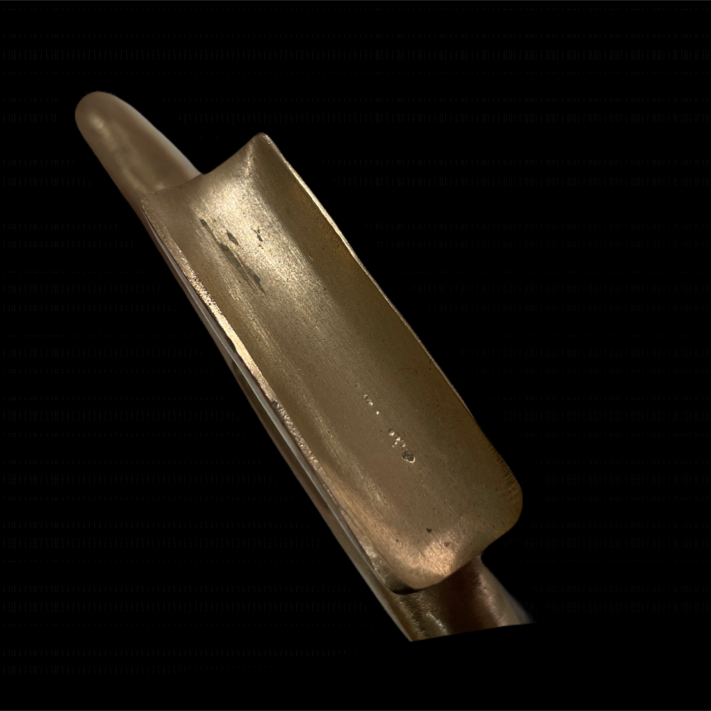 Close-up of a brass instrument mouthpiece on a black background