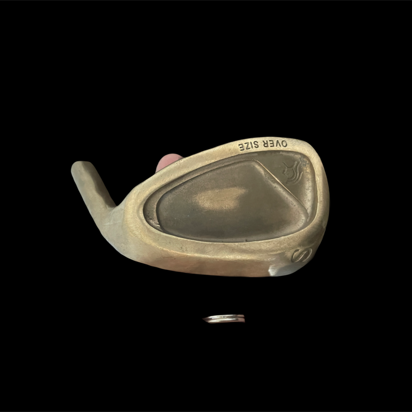 Golf club head on a black background