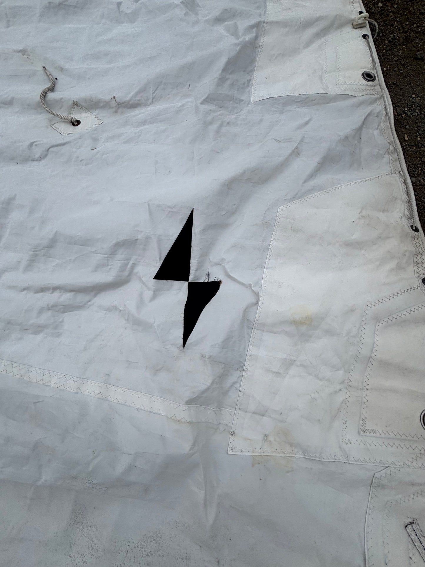 White fabric with black arrow design on a textured background
