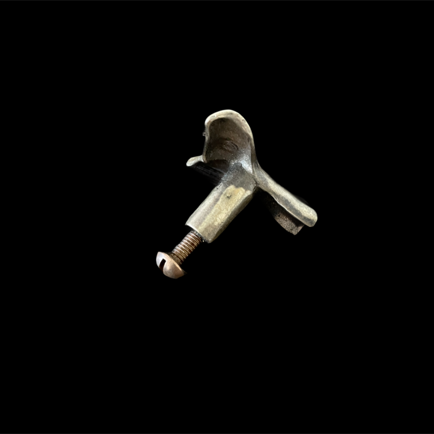 Metallic object with a screw on a black background