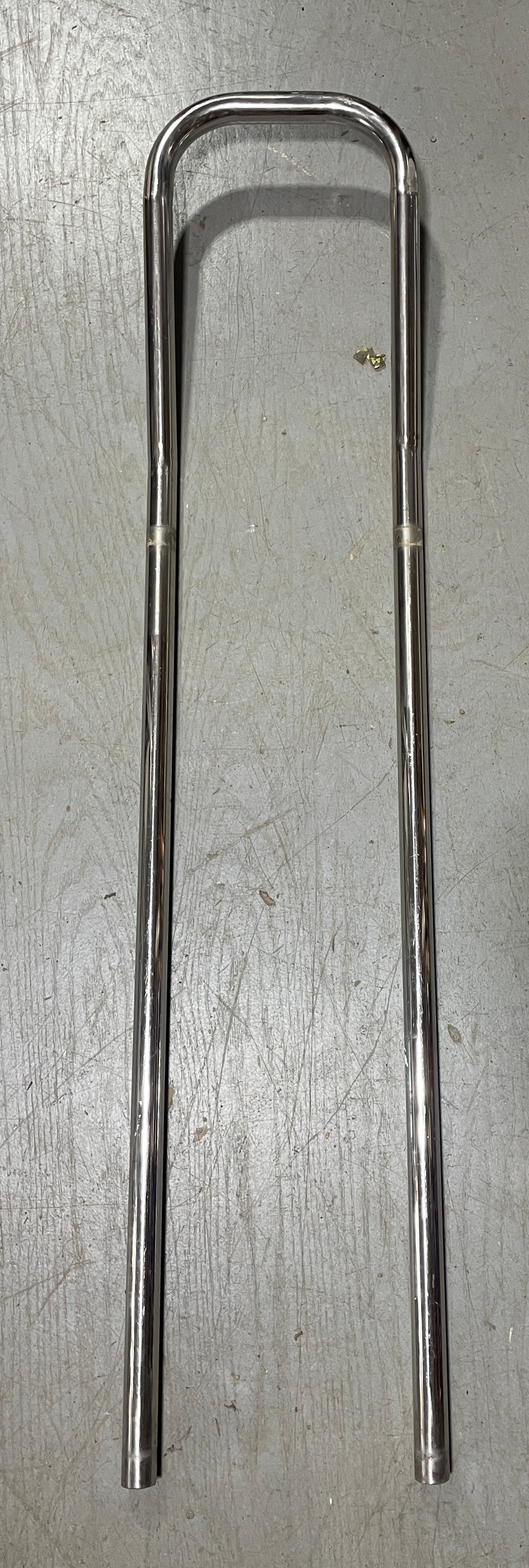 Metallic object on a gray surface