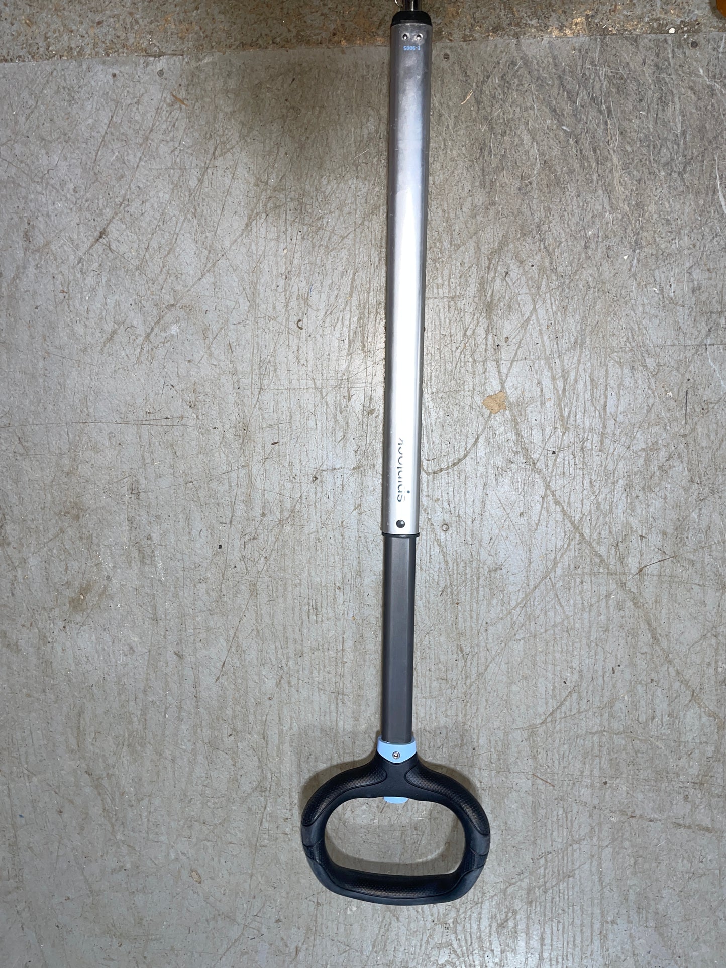 Metal tool with a black handle on a textured surface