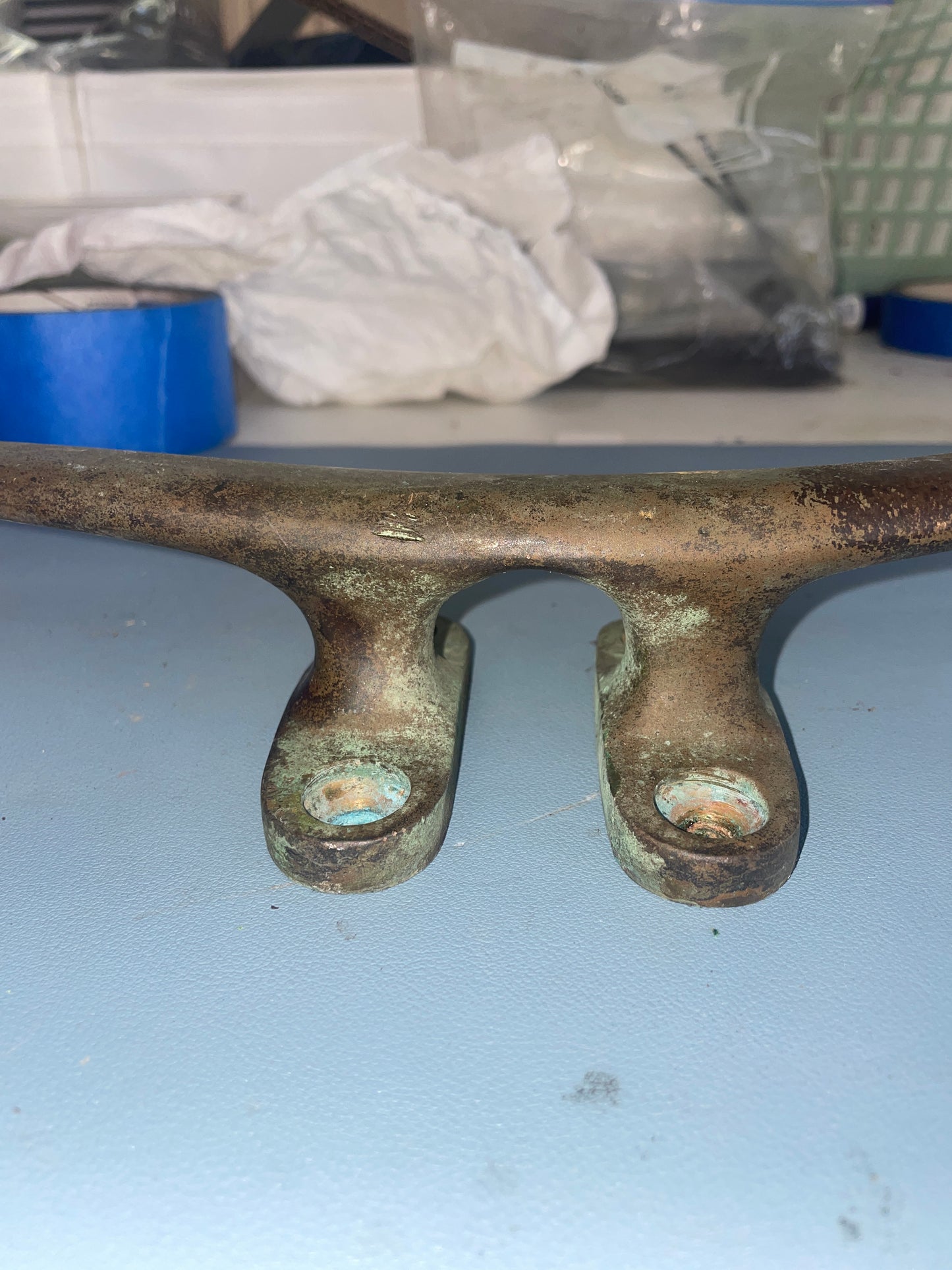 Rust-covered metal key on a light blue background