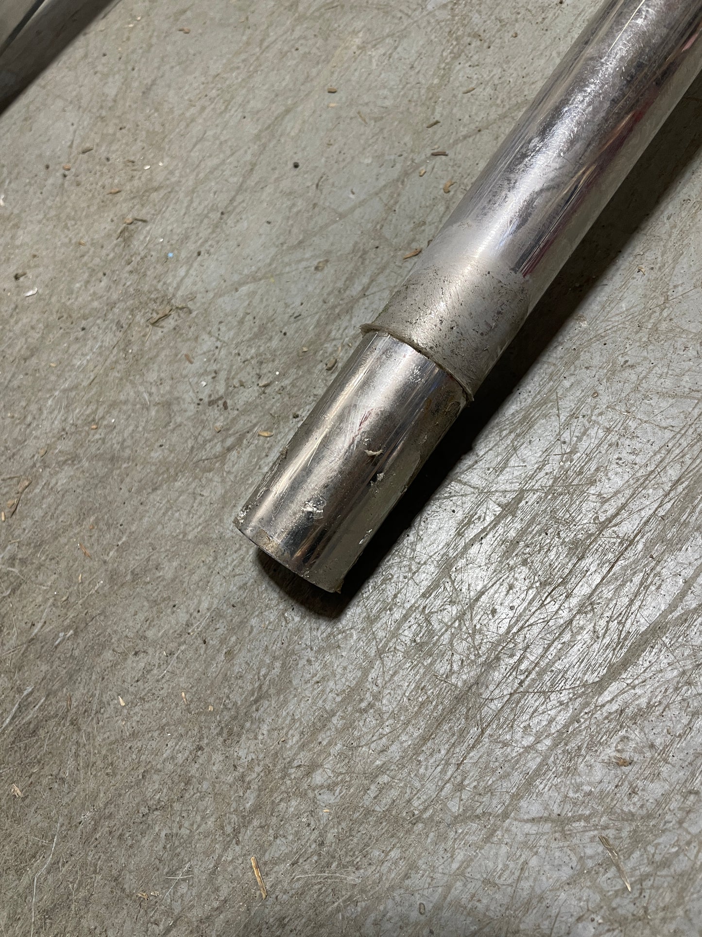 Metal rod on a textured concrete surface