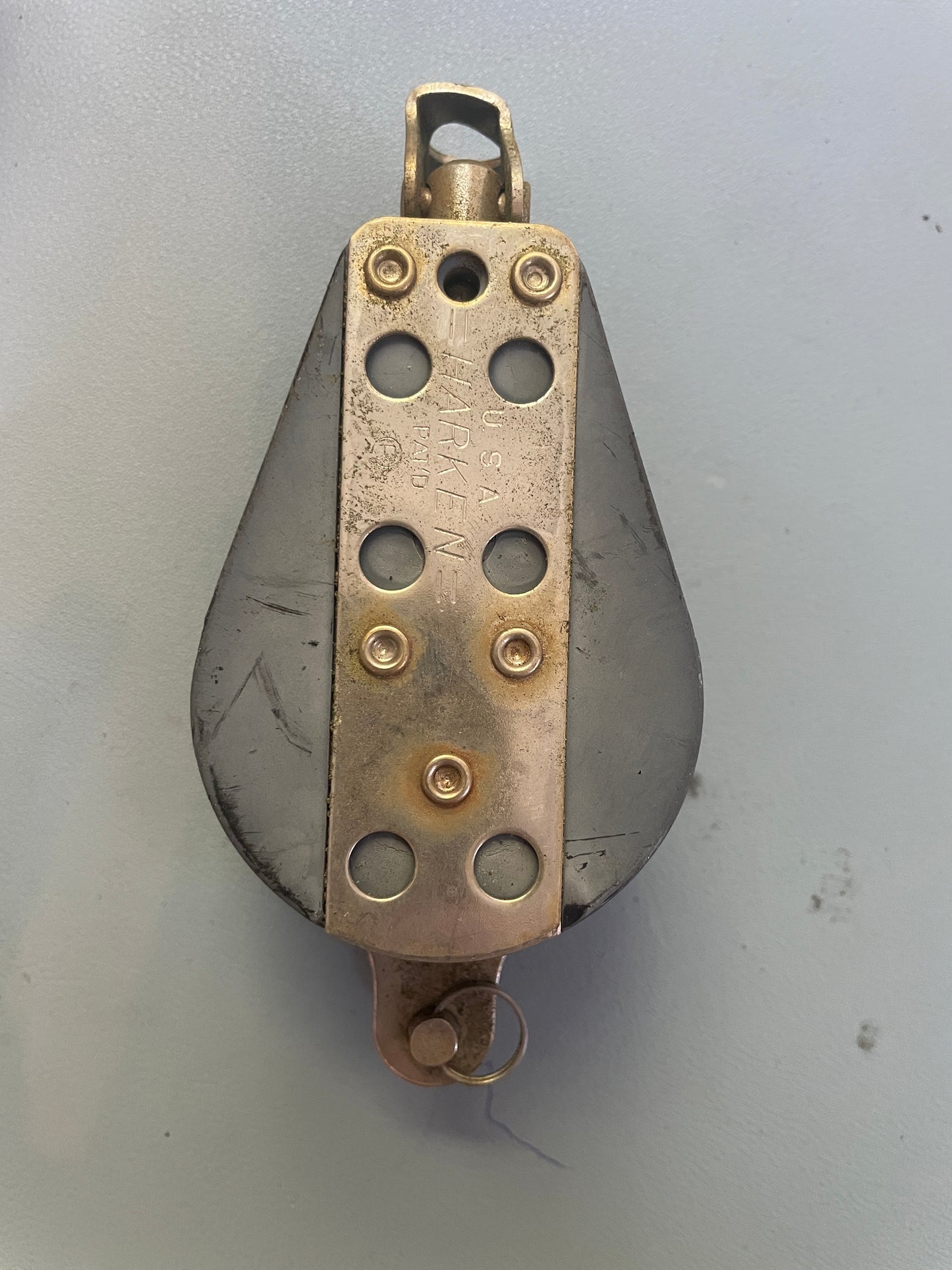 Metallic object with 'Harken' branding on a gray background