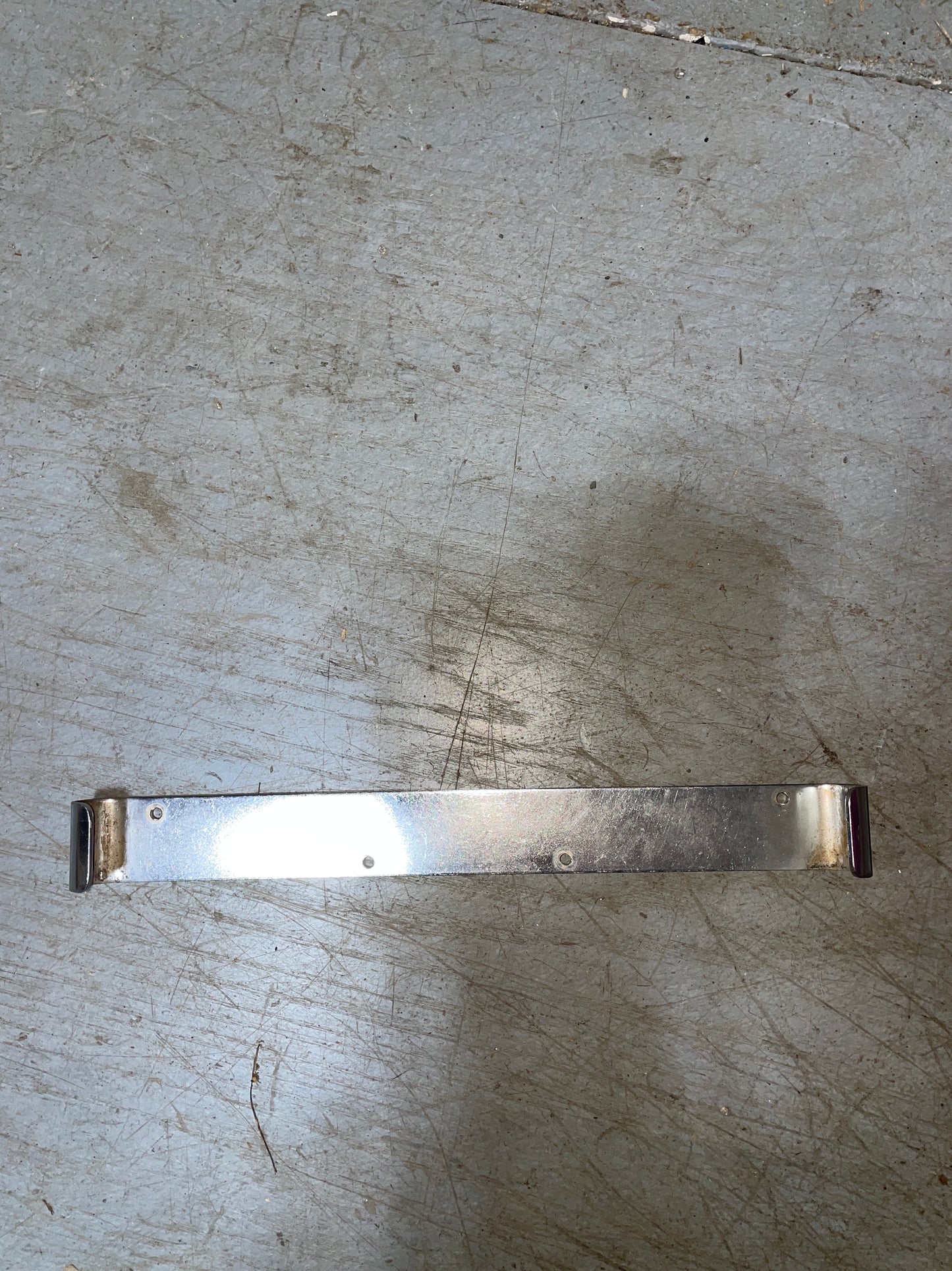 Metallic strip on a textured gray surface