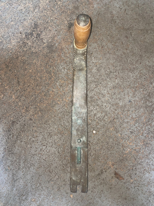 Metal tool with a cylindrical head on a concrete surface