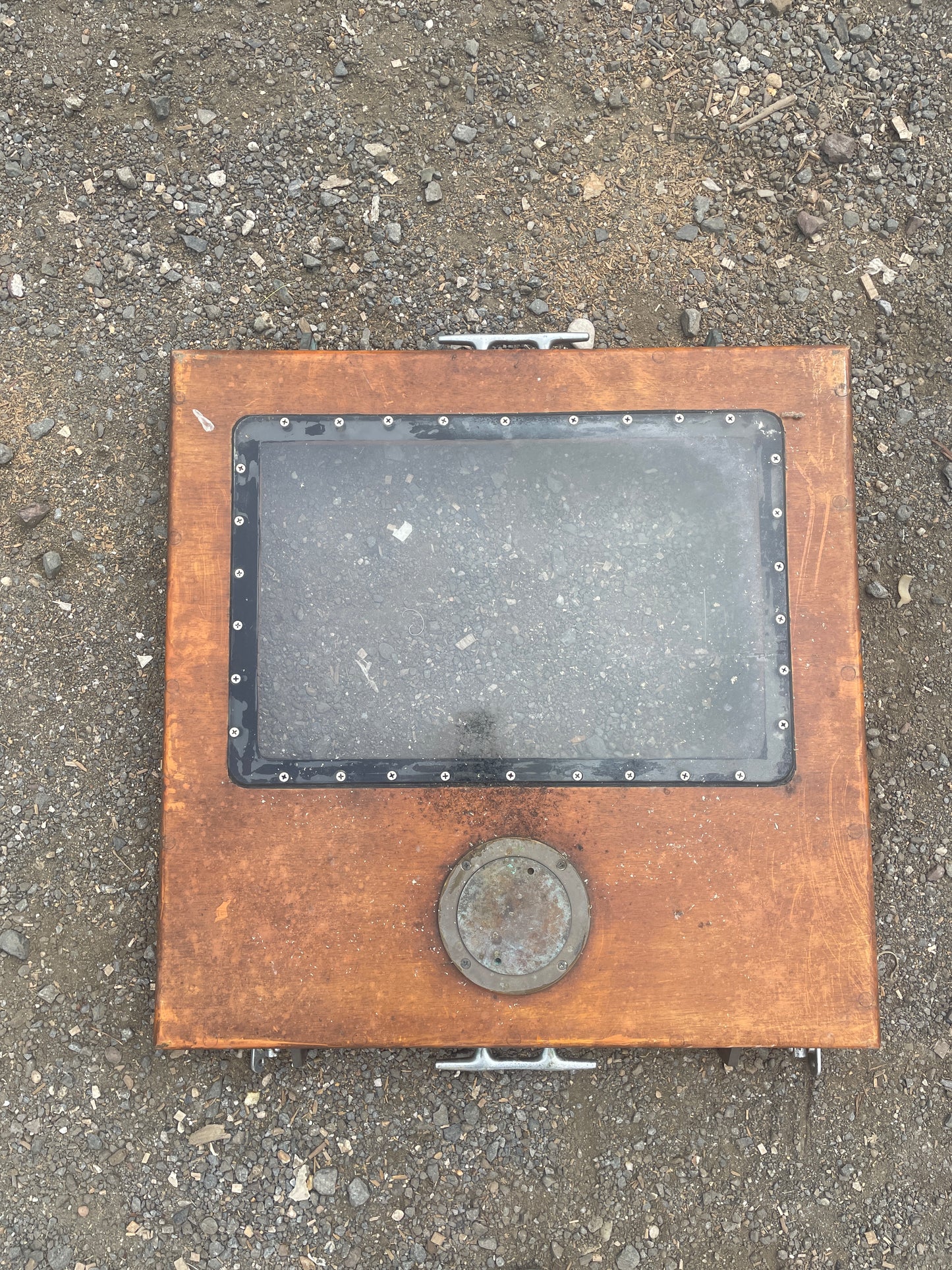 Metal manhole cover on a concrete surface