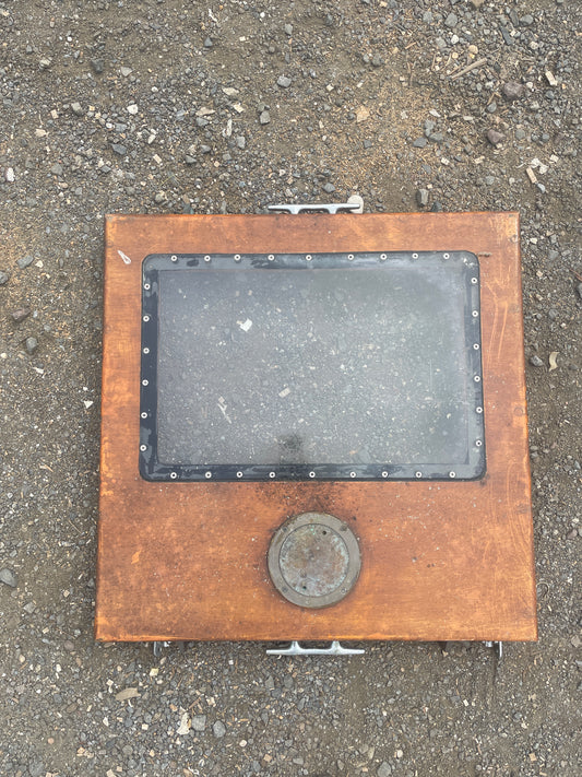 Metal manhole cover on a concrete surface