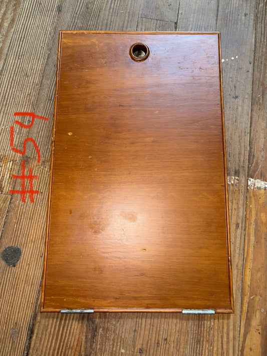 Wooden board with a hole on a wooden surface