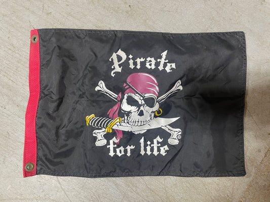 Pirate-themed flag with skull and crossbones design on a gray surface