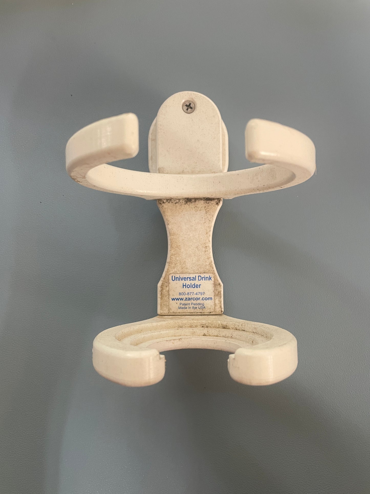 Beige plastic hanger on a gray background