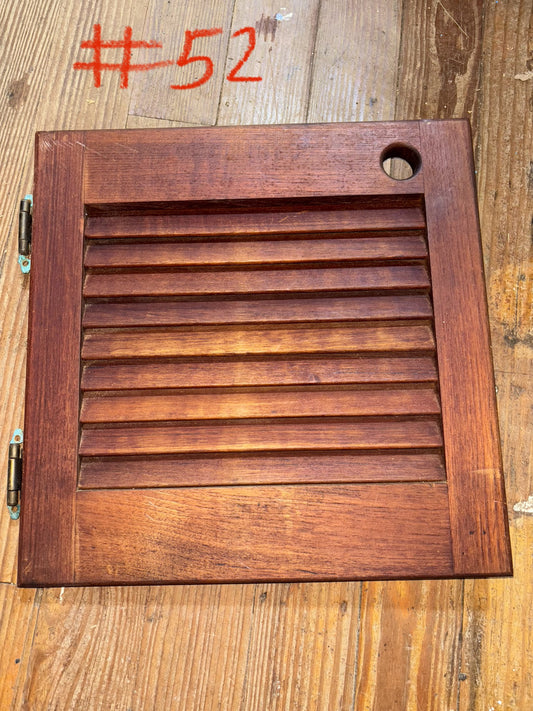 Wooden panel with slats on a wooden surface, labeled '#52'.