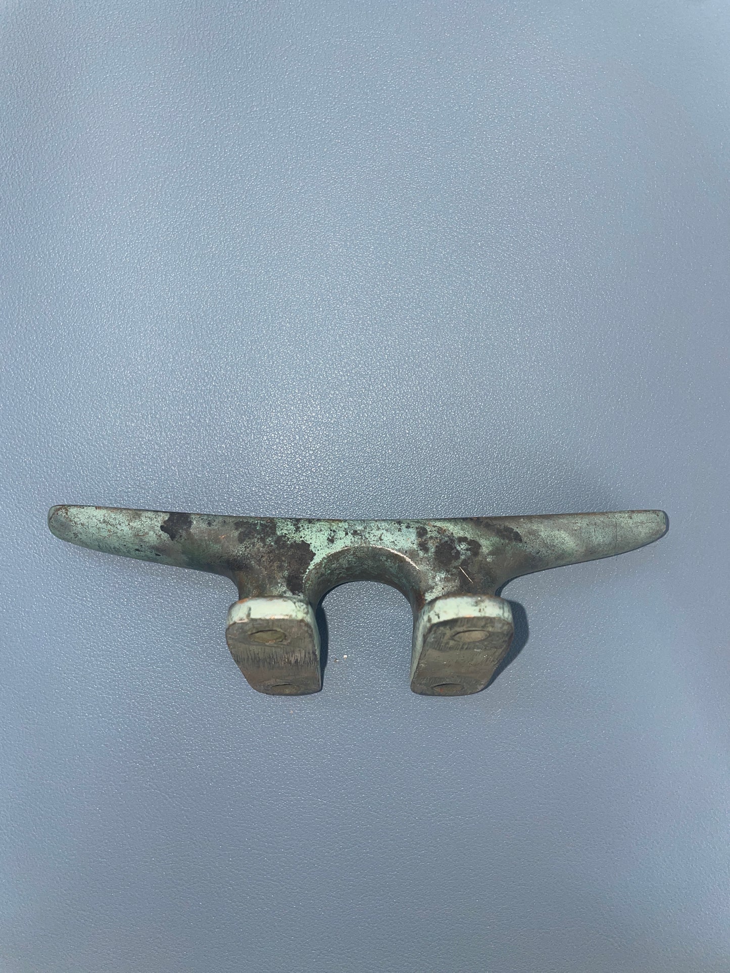 Bronze cleat on a gray background
