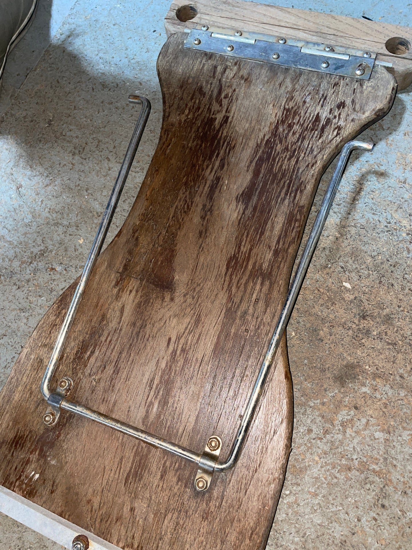 Wooden bracket with metal frame on a concrete surface