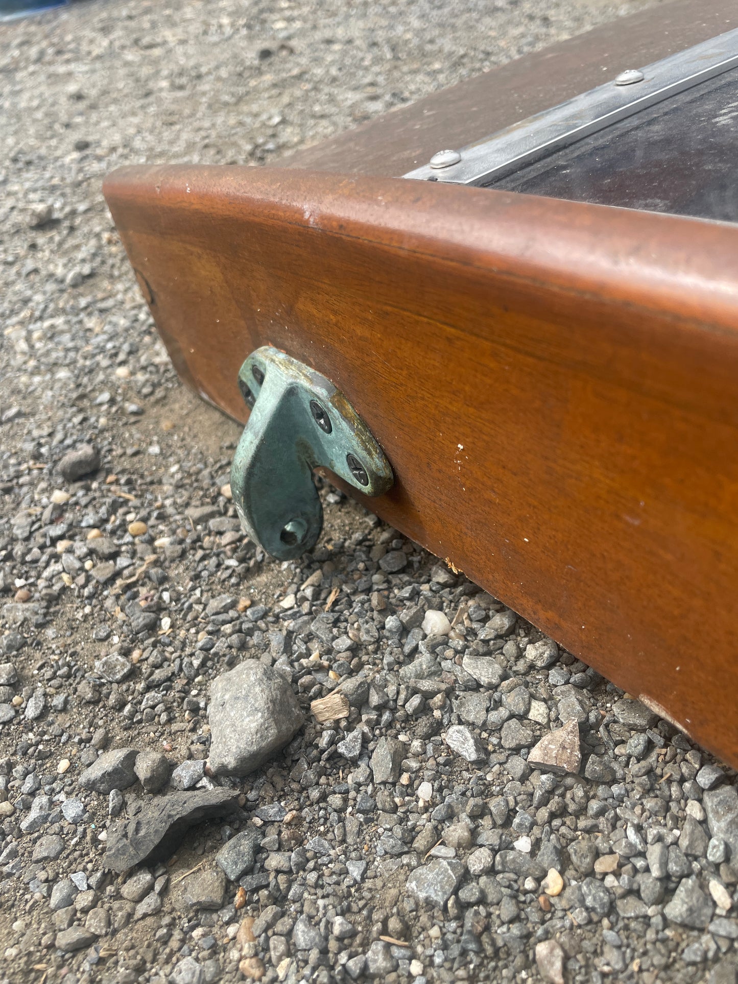 Wooden door handle on a door set against a textured pavement background