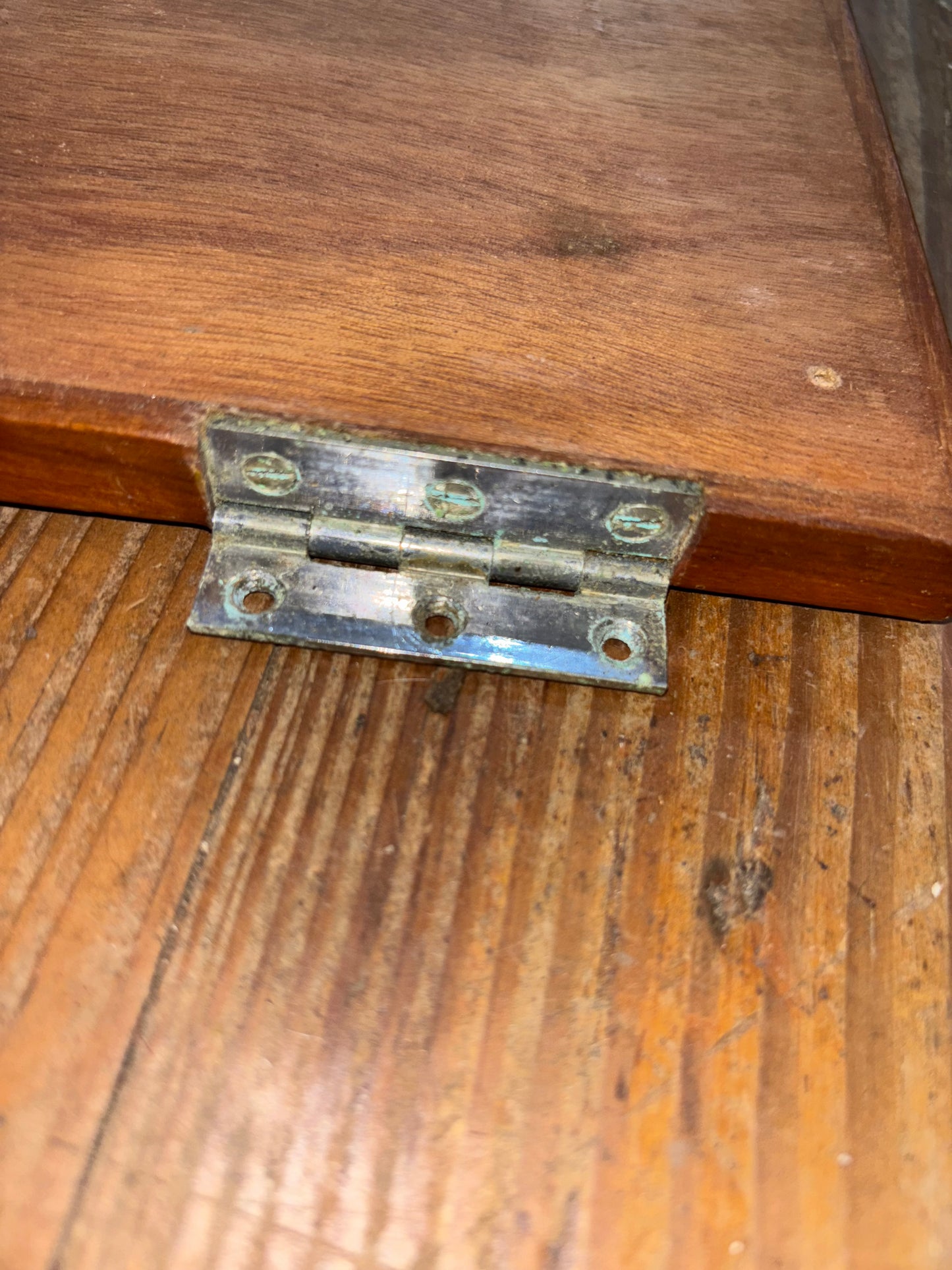 Metal hinge on a wooden door