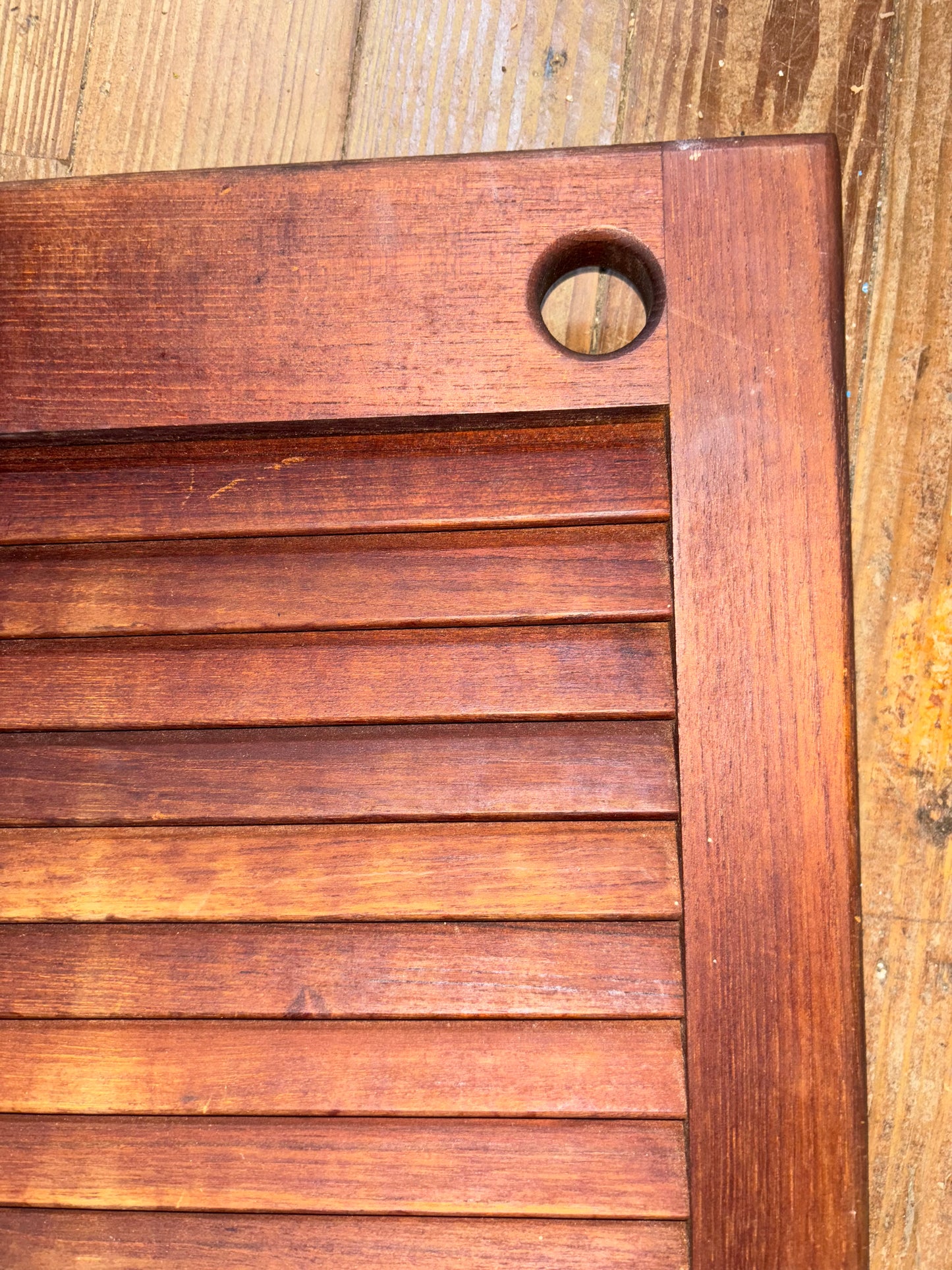 Close-up of a wooden surface with a circular hole