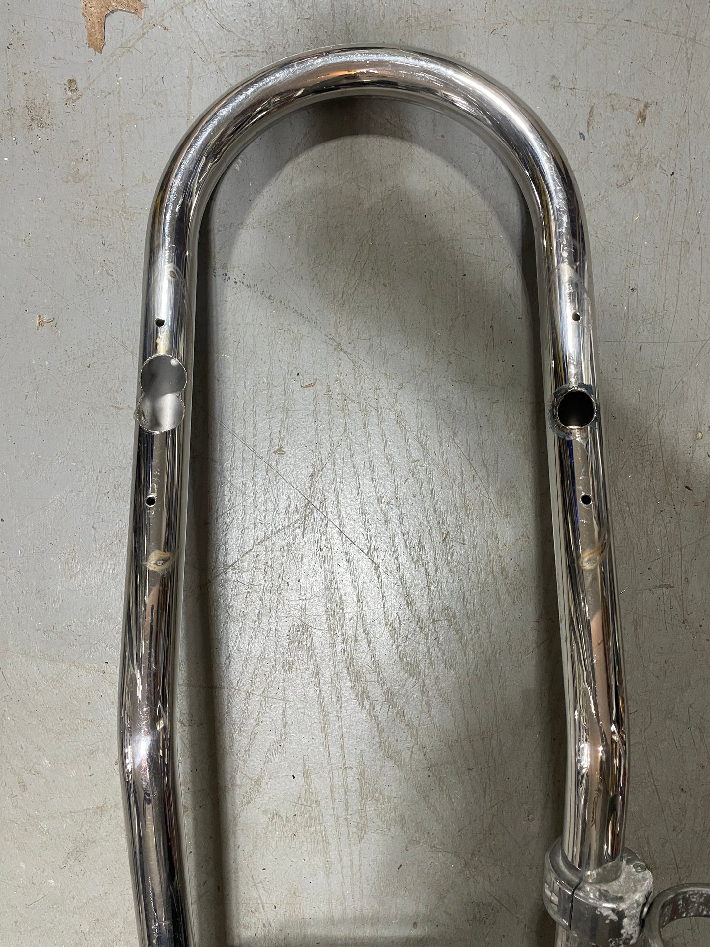 Chrome metal bar on a textured gray surface