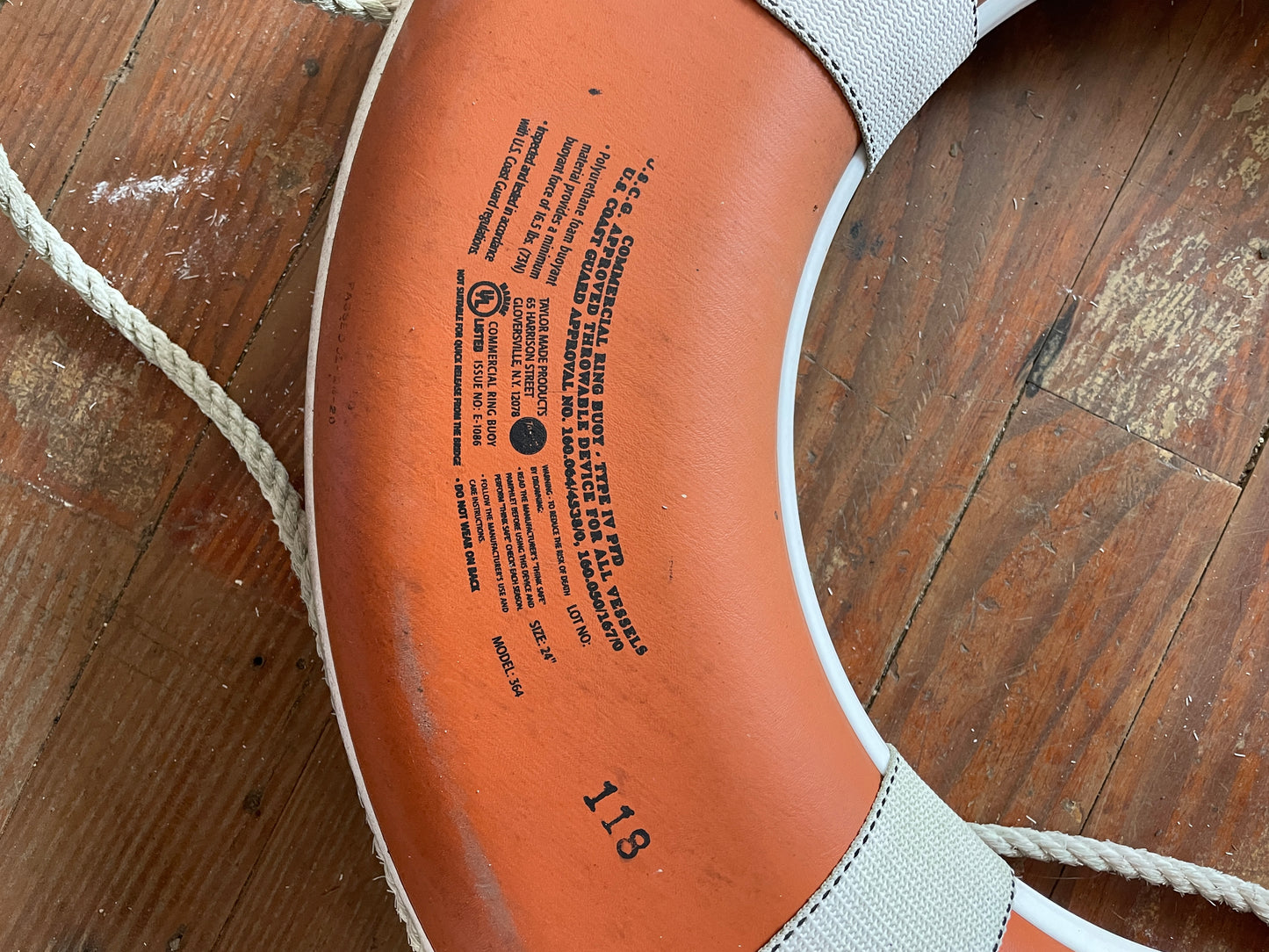 Close-up of a shoe sole with text on a wooden floor