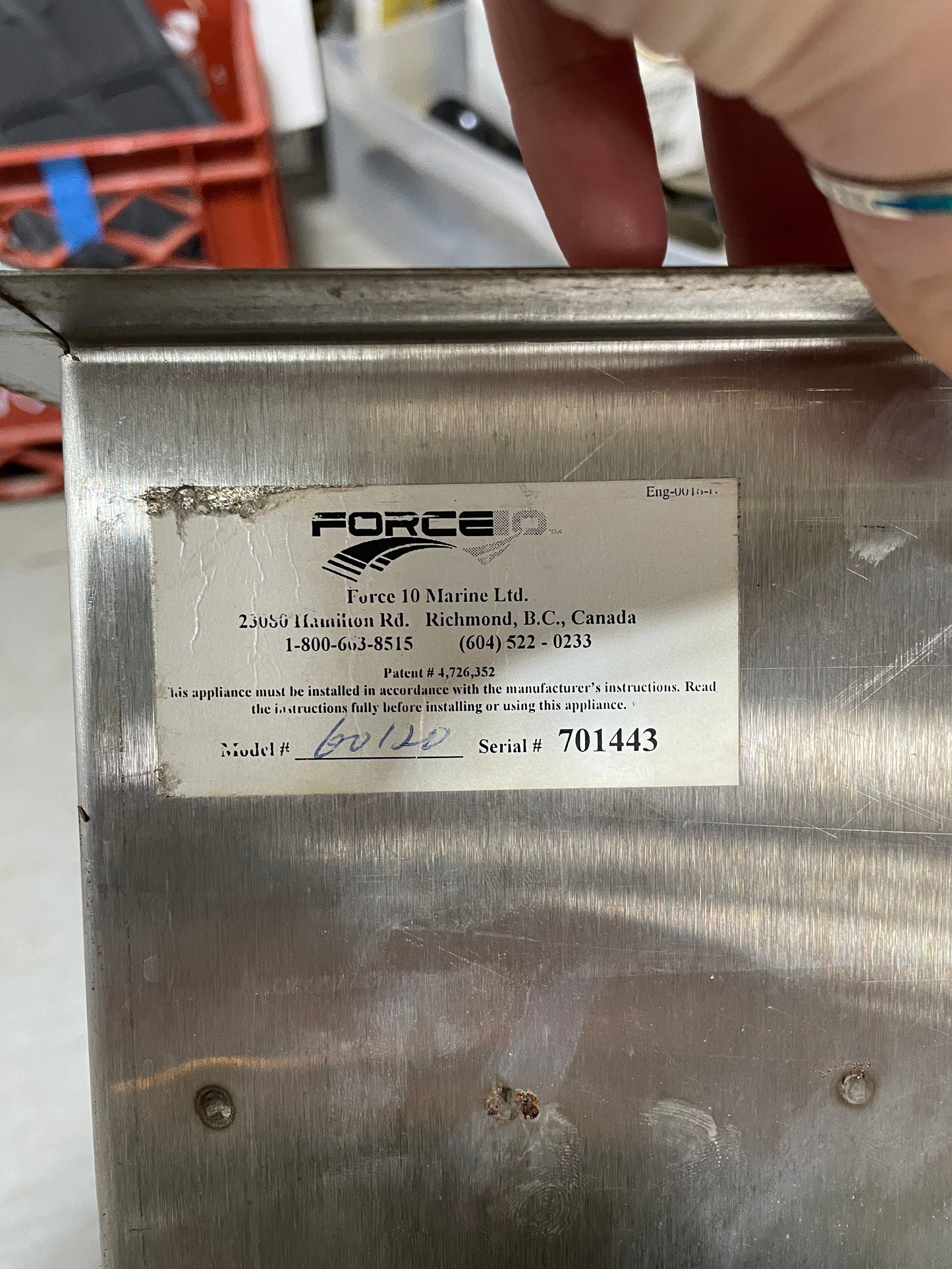 Metal box with a Force D label on a blurred background