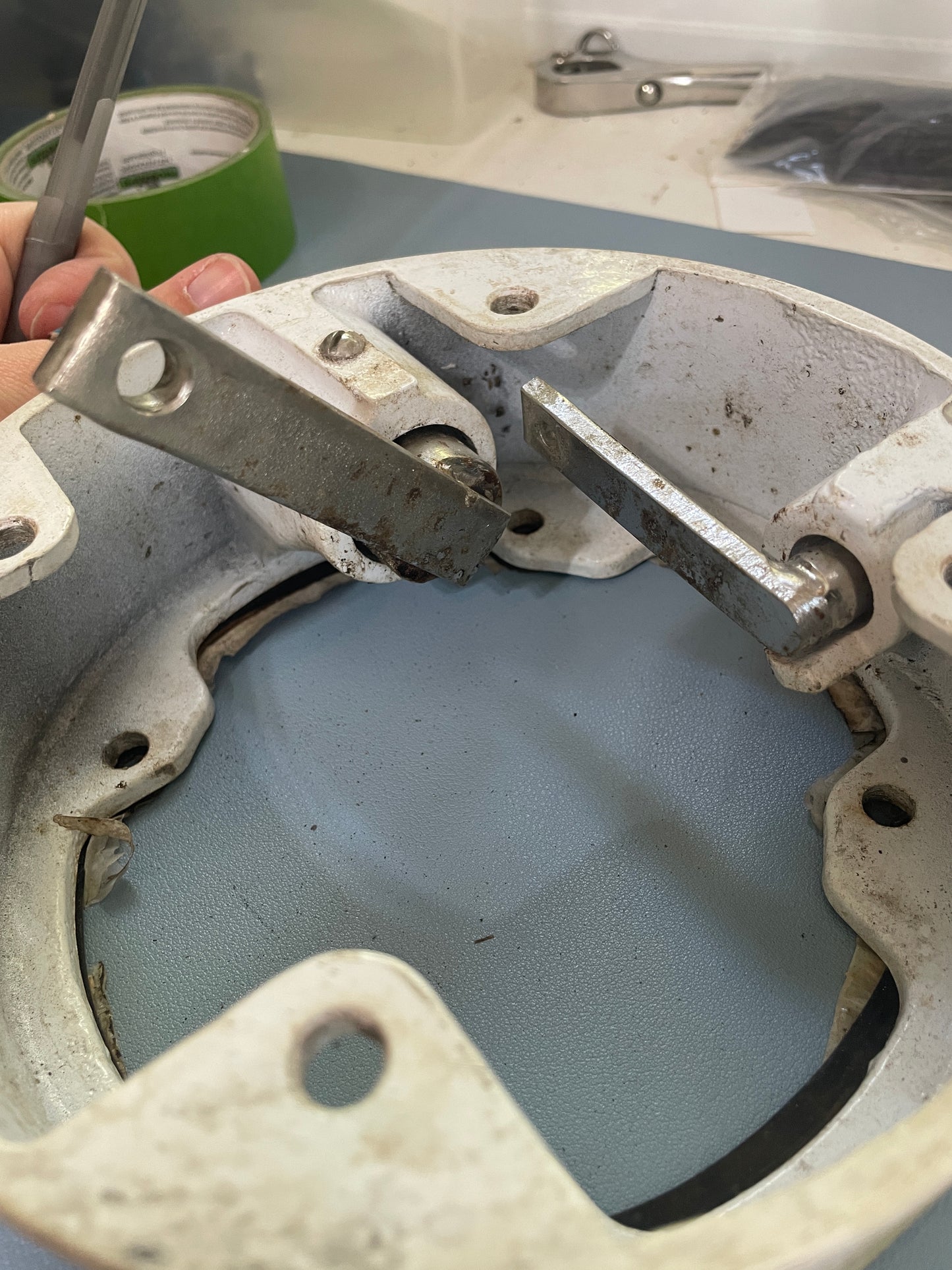 Close-up of a mechanical component being worked on with a tool.