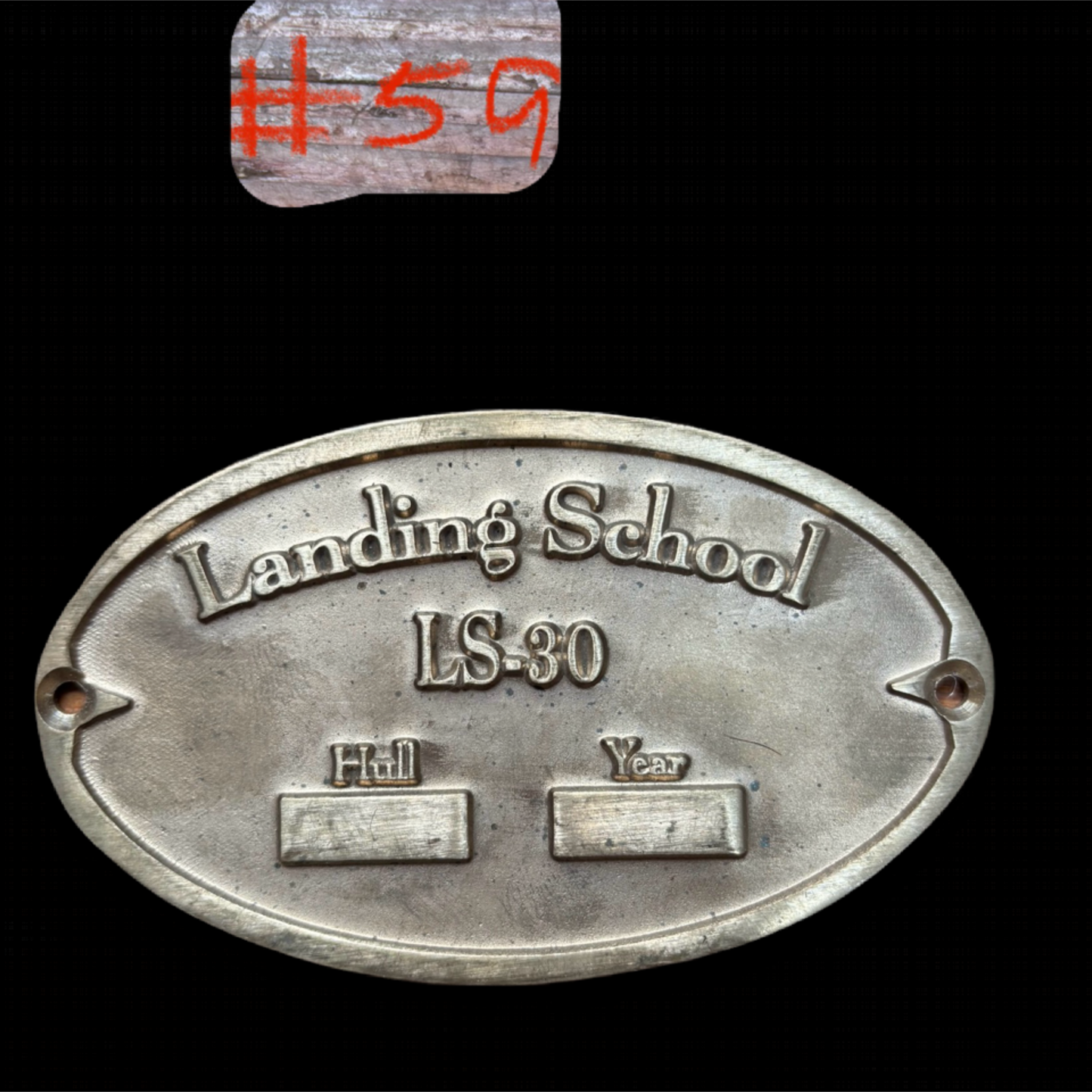 Metal plaque with 'Landing School LS-30' text on a black background