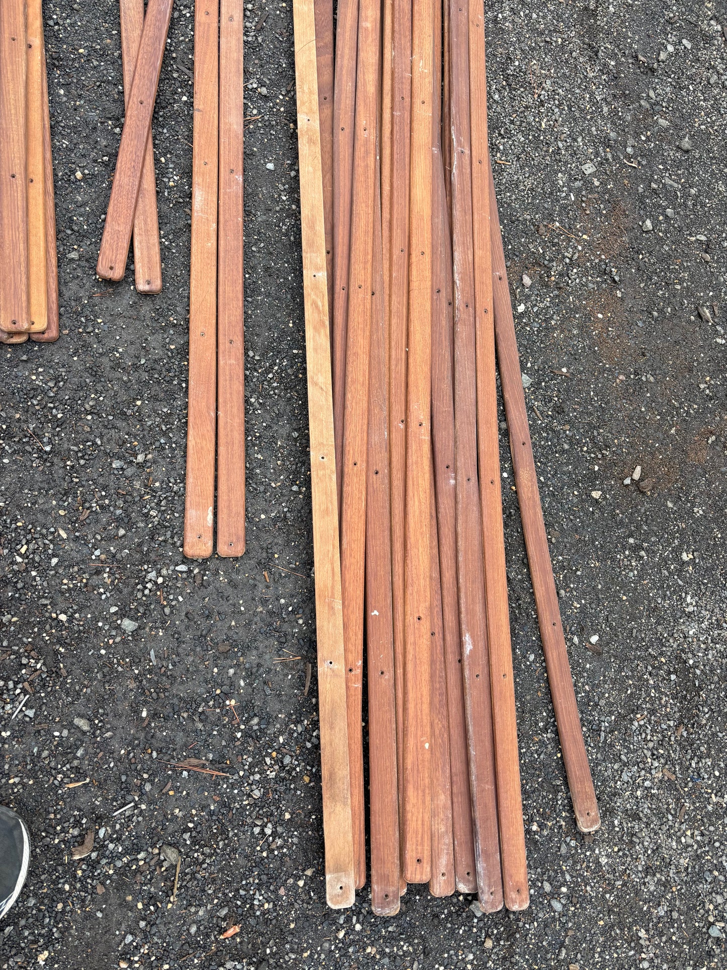 Wooden stakes on a dark asphalt surface