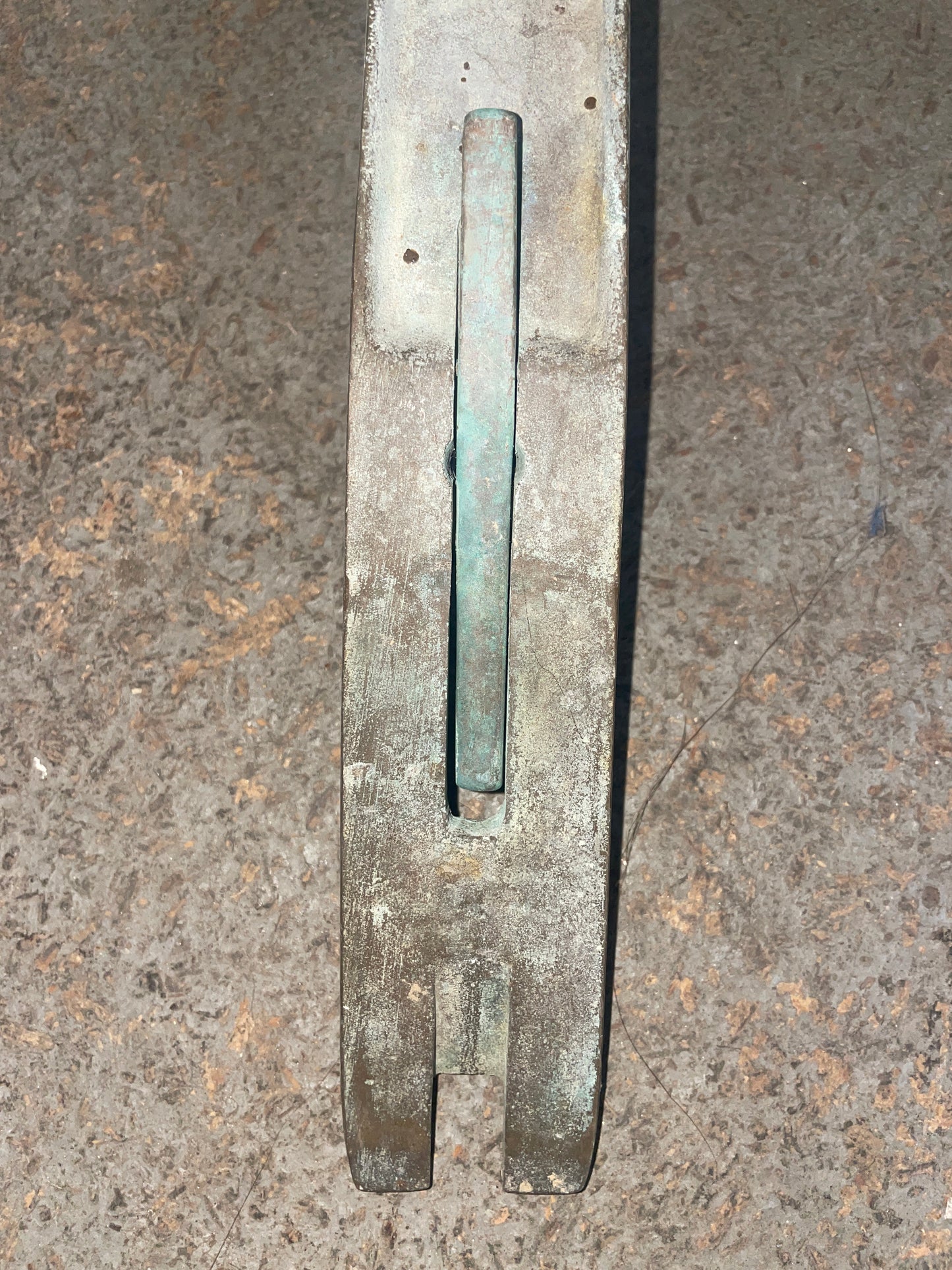 Metal tool on a textured concrete surface