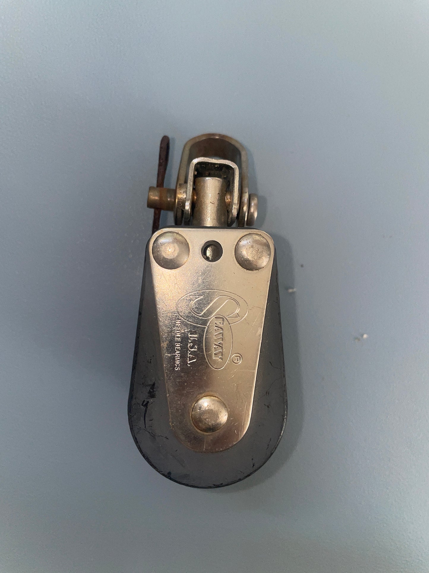 Metallic pulley system on a gray background