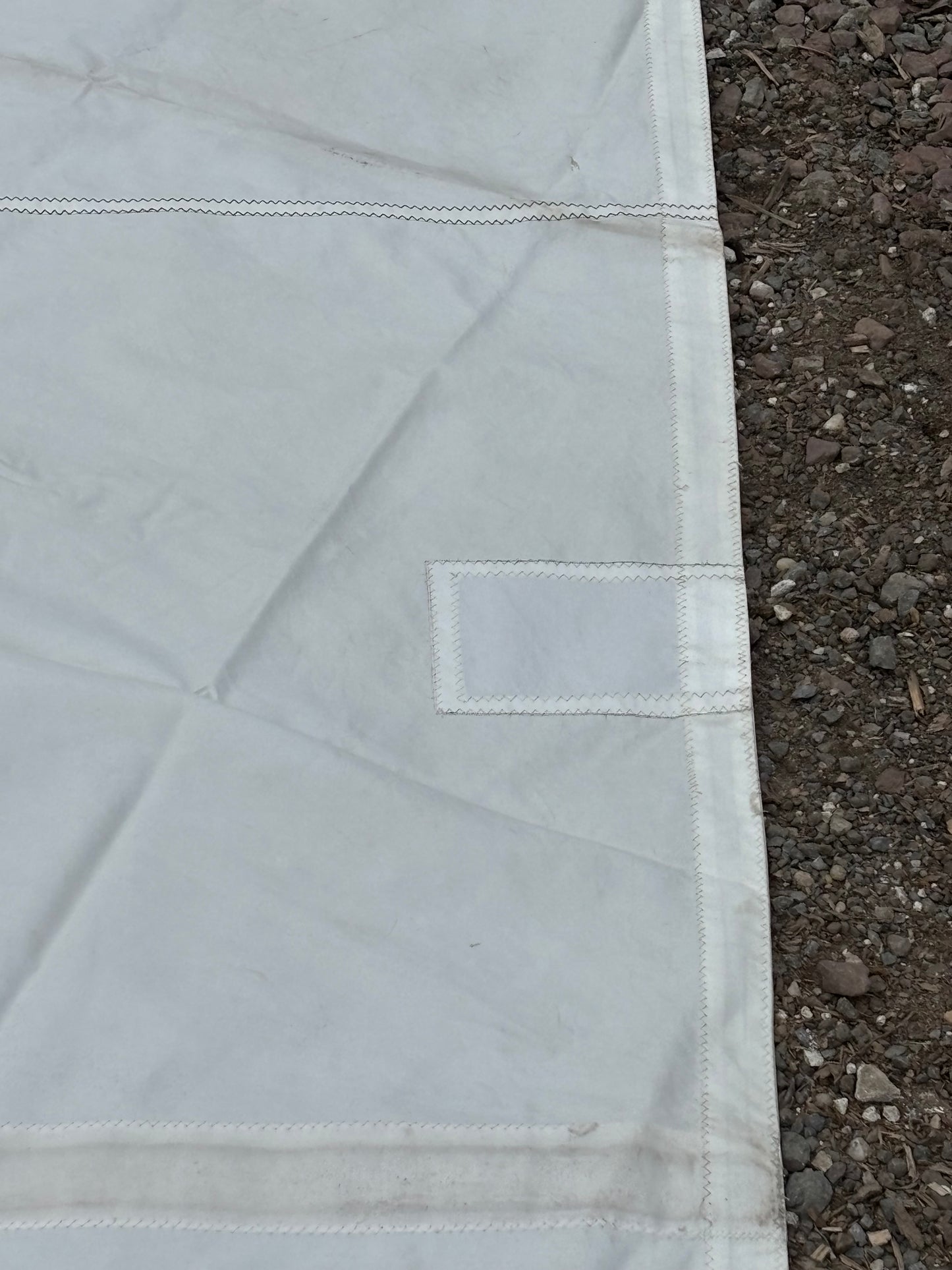 Close-up of a white fabric with a label on a dark ground