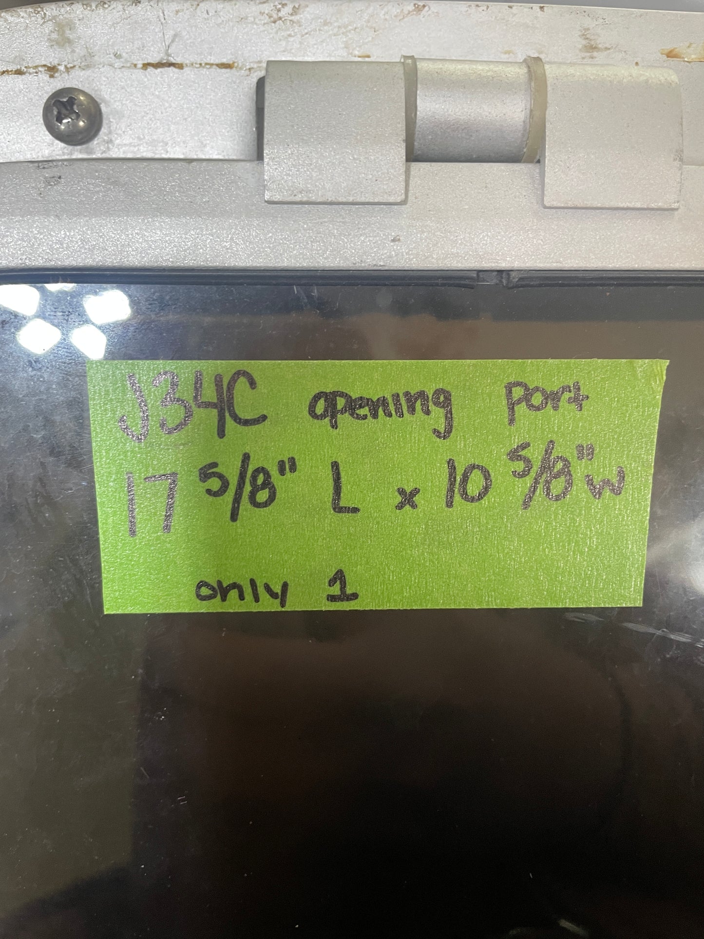 Metal door handle with a green label providing dimensions and text.