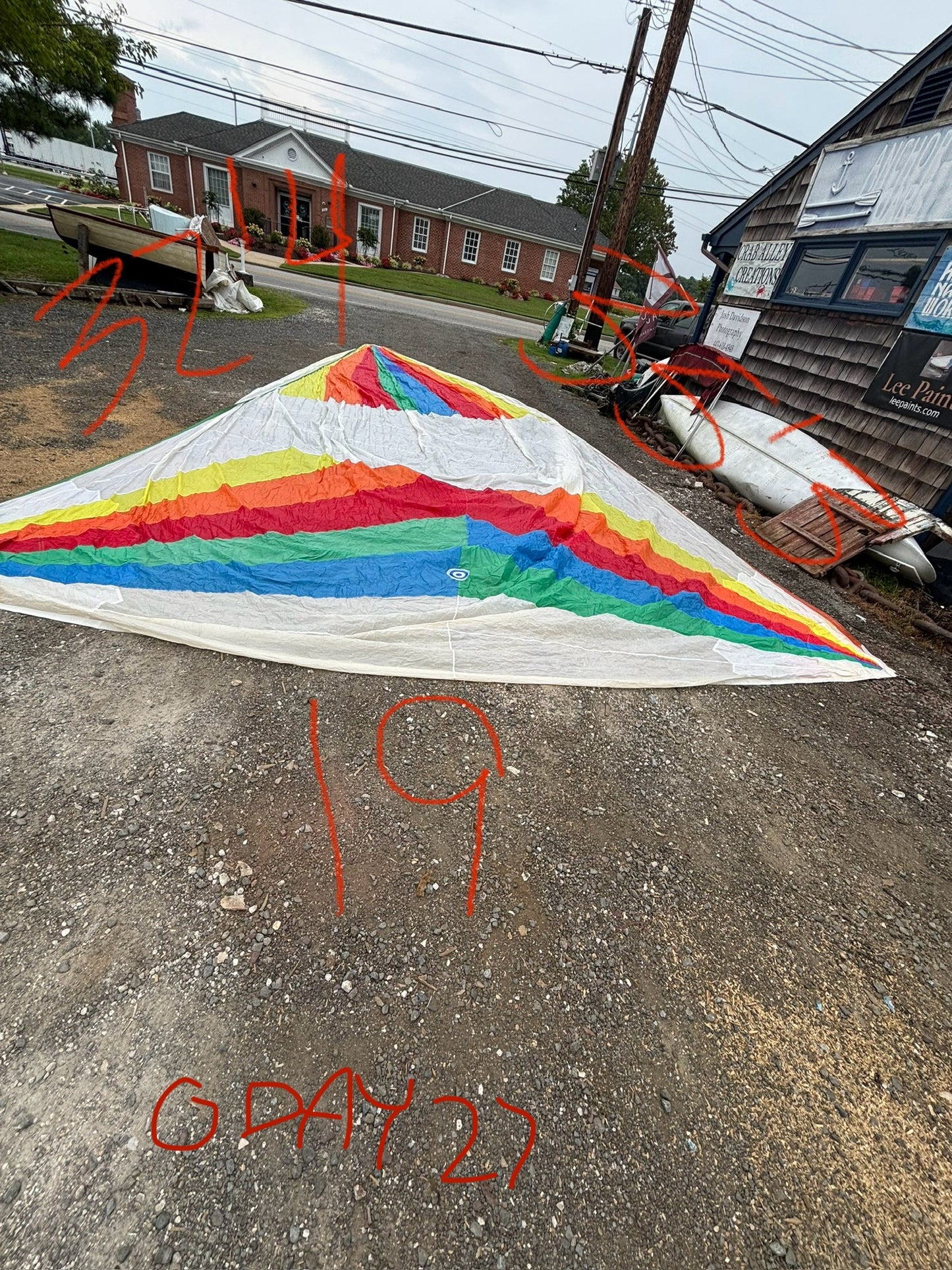 Colorful kite on a street with numbers and letters written on it
