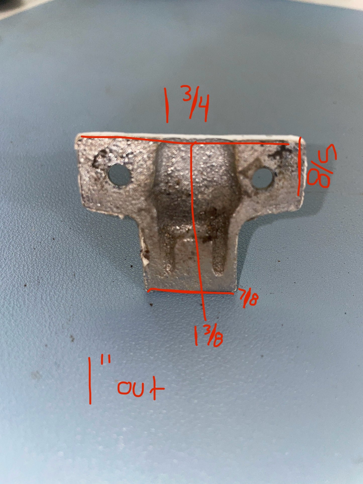 Metal bracket with measurements marked in red on a gray background