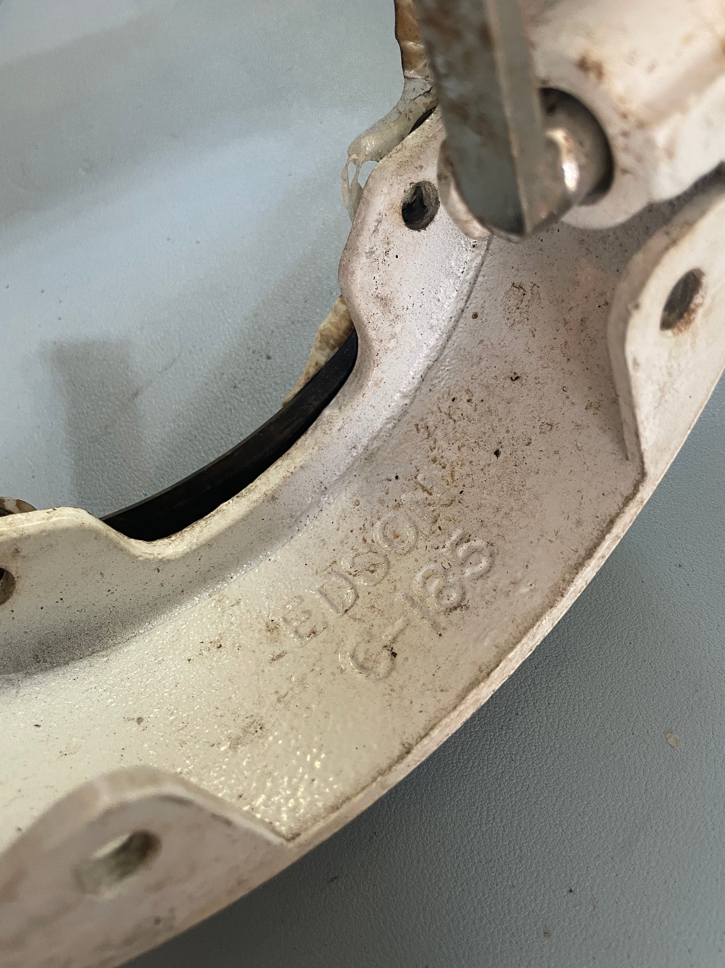 Close-up of a metal brake rotor with visible branding on a gray background