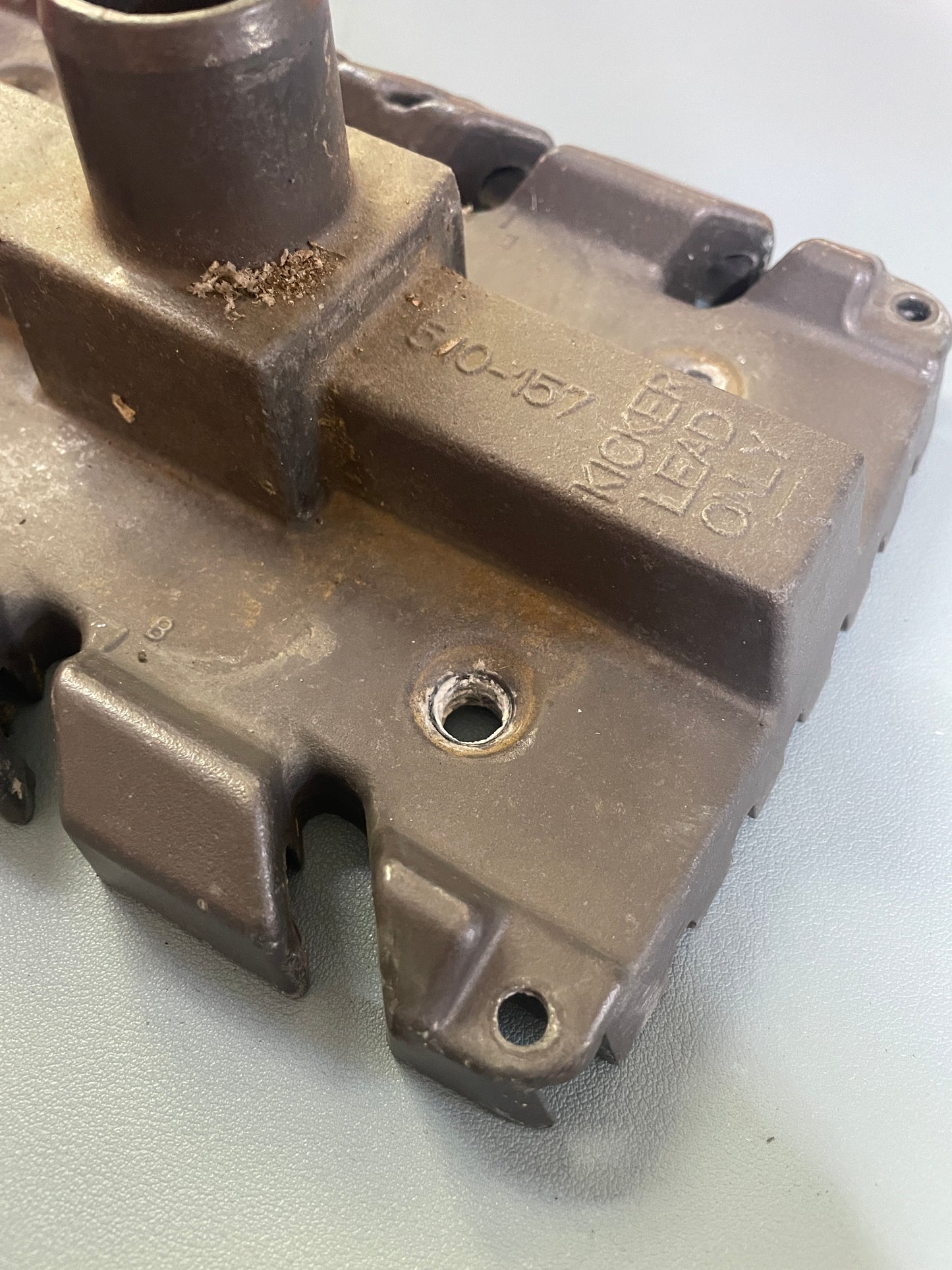 Metal mechanical component with visible branding on a light background