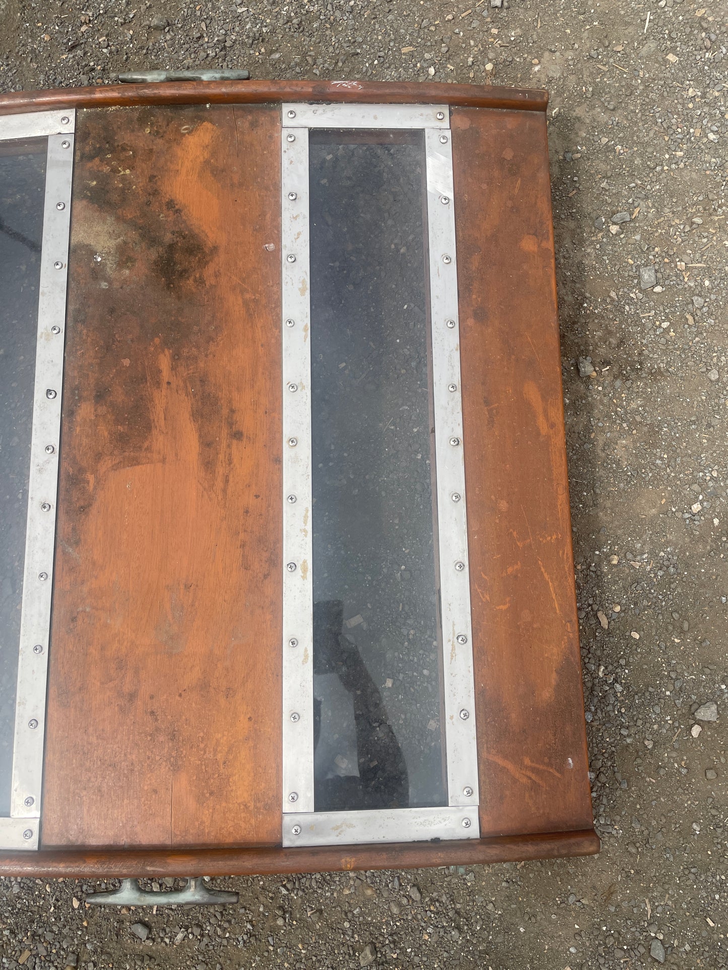 Wooden box with metal accents on a concrete surface