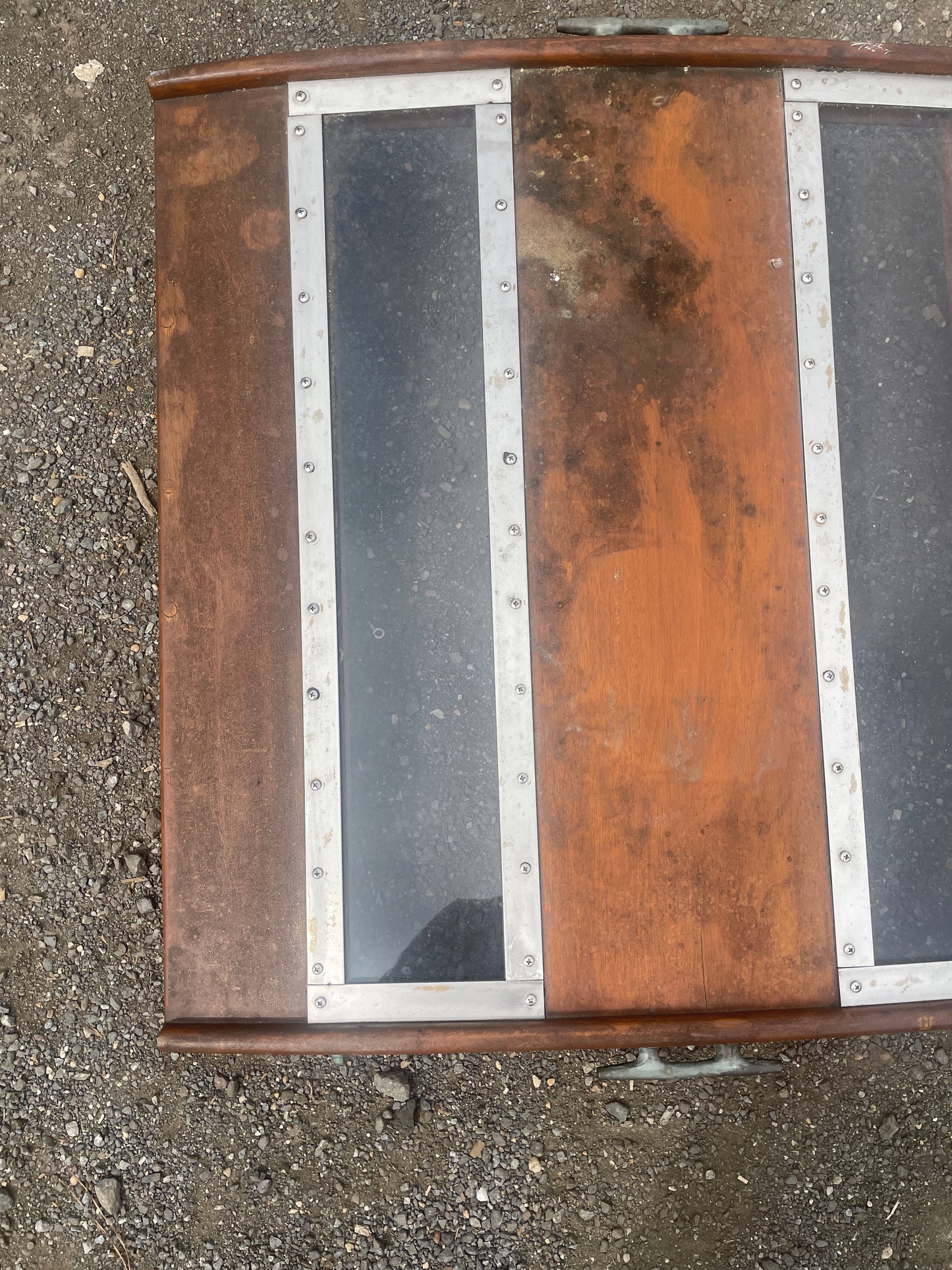 Wooden box with metal accents on a concrete surface