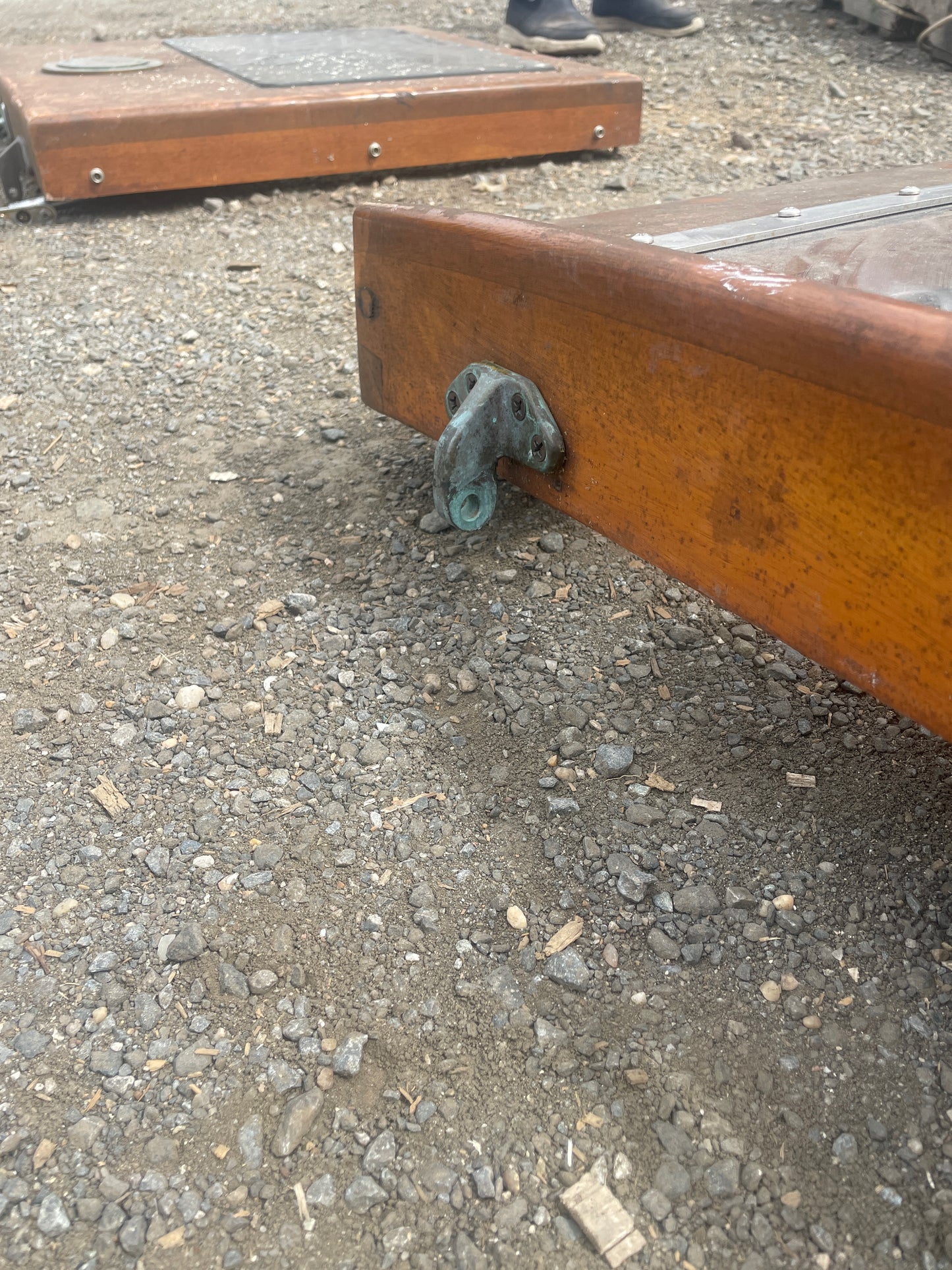 Wooden bench leg on a concrete surface