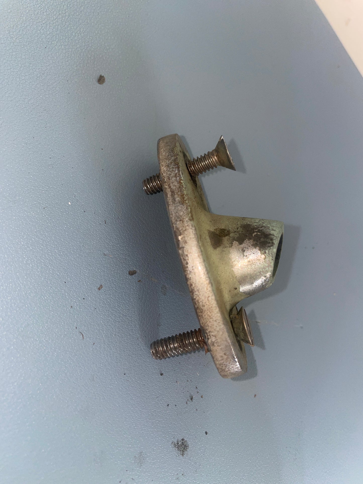 Metal bracket with screws on a light gray background