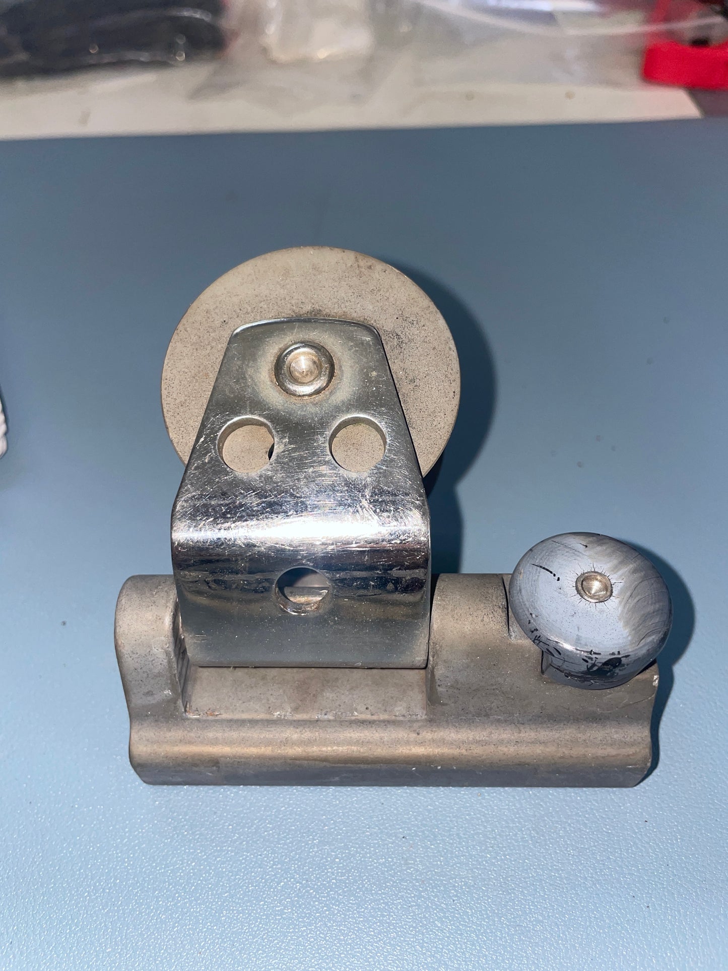 Metal door hinge on a blue door