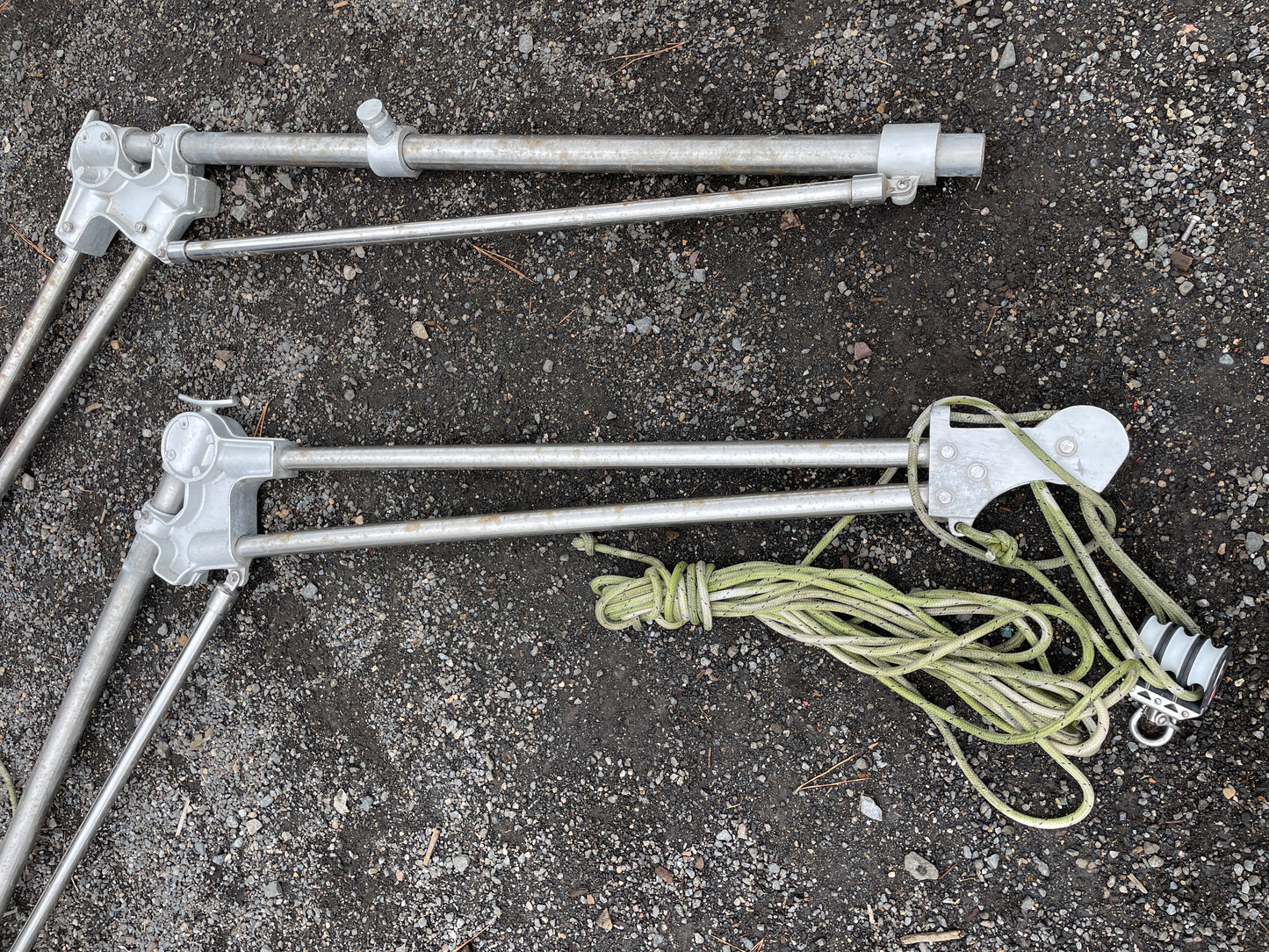 Metal tent stakes with ropes on a concrete surface