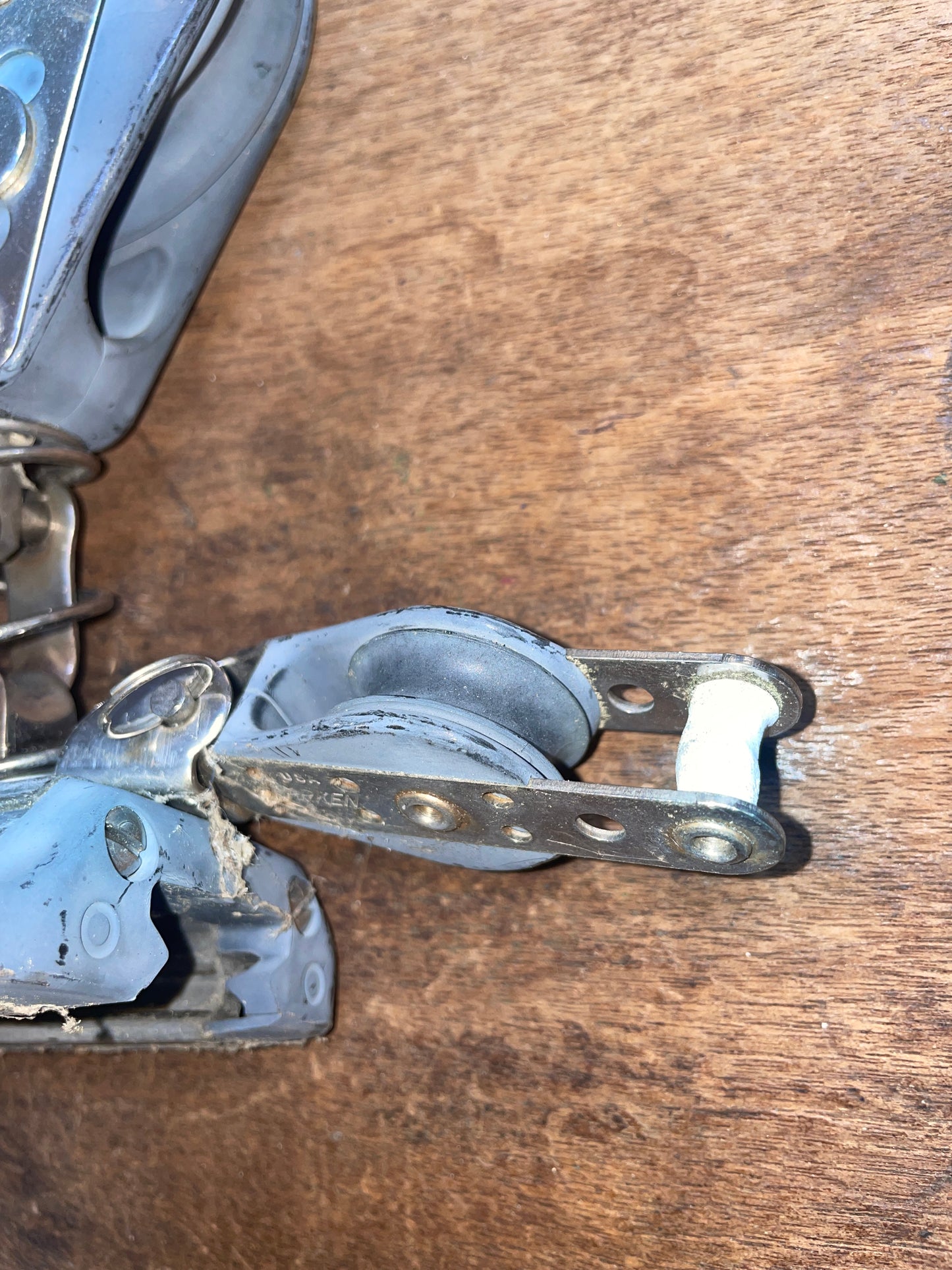 Metal door hinge on a wooden surface
