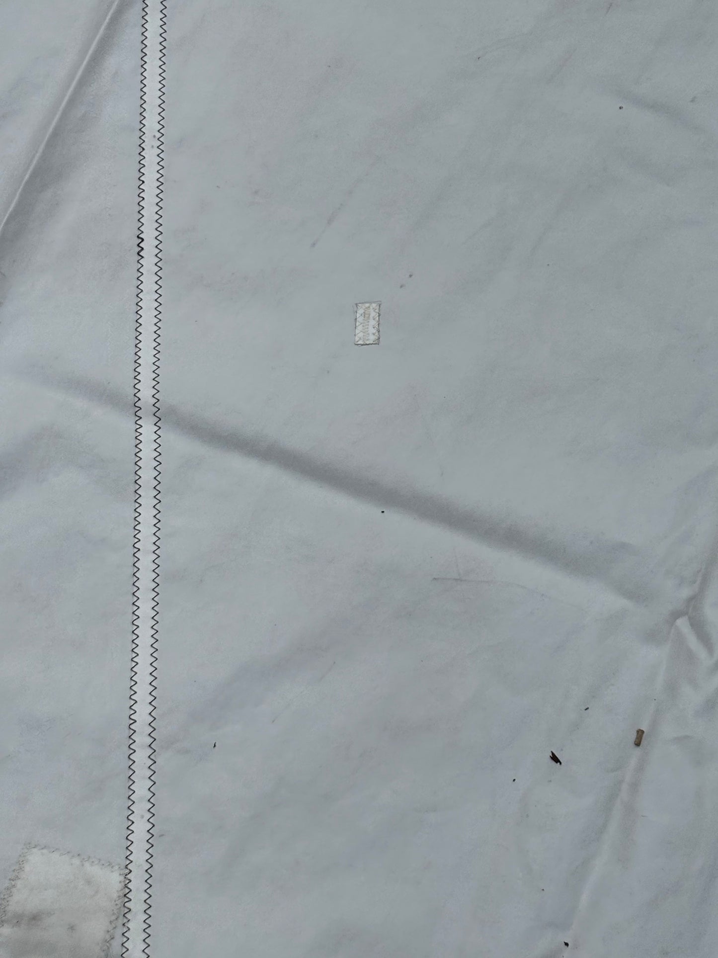 Gray fabric with a brand logo on a white background